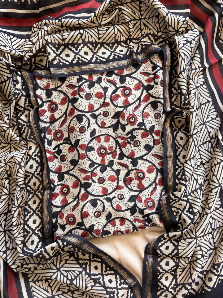 Maheshwari fabric suit with Kalamkari floral print in black, ivory, and maroon tones, featuring traditional hand-block designs and striped dupatta.