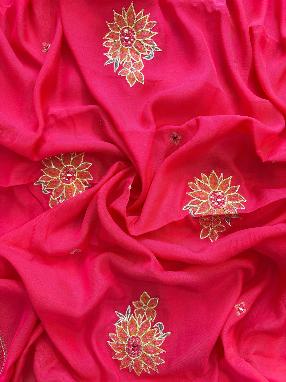 Pink linen suit with mirror work embroidery and applique floral dupatta.