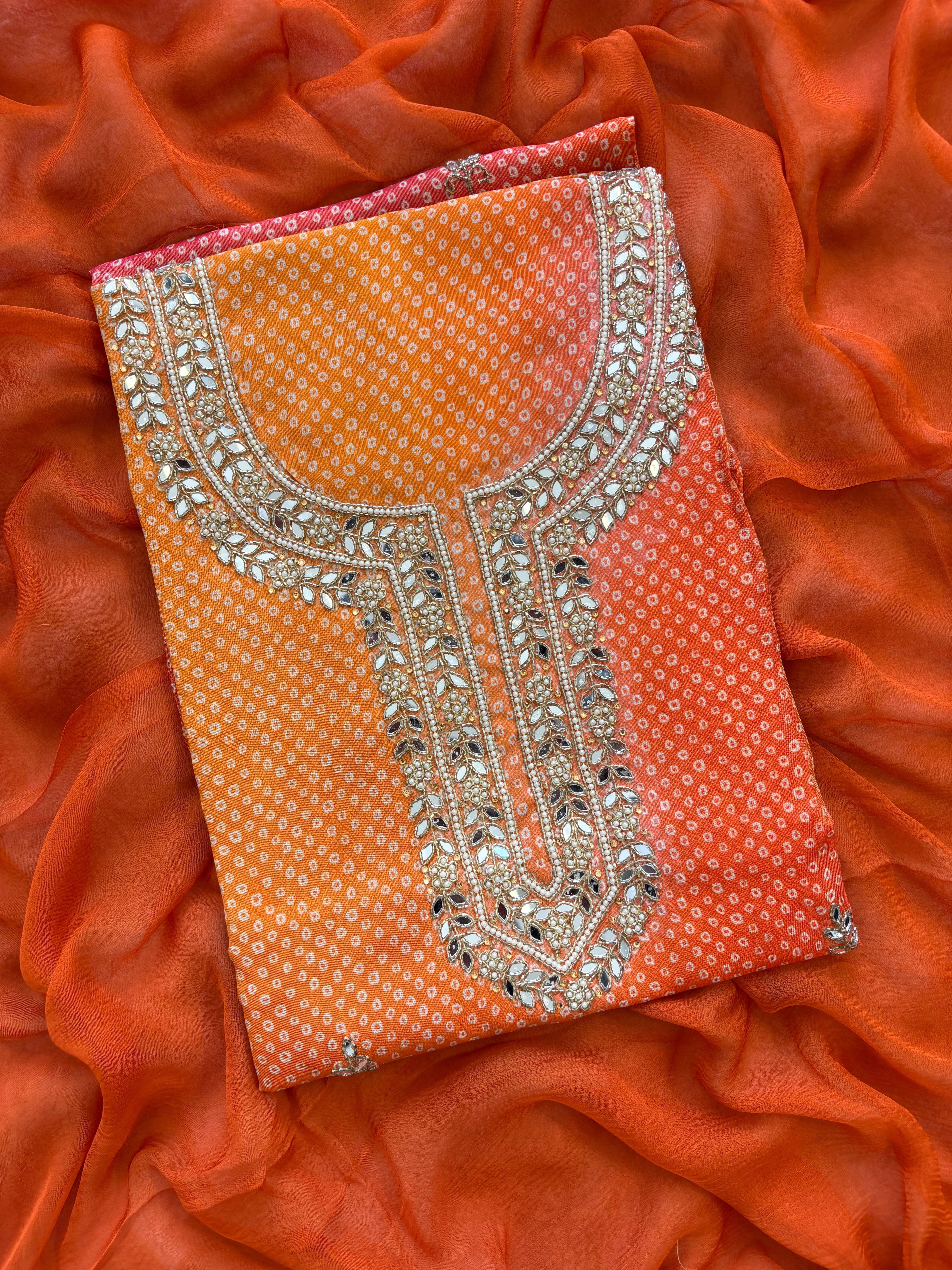Orange Shimmer organza bandhani suit with ombre effect and chiffon dupatta with lace border.