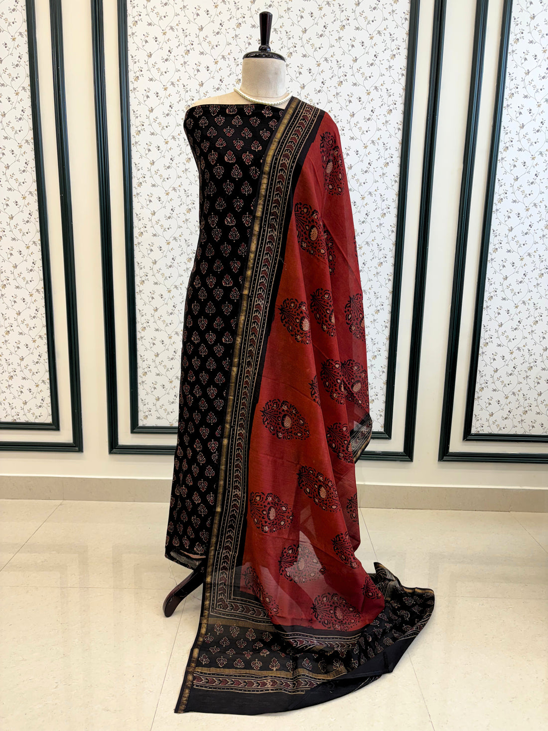Black Maheshwari silk unstitched suit with hand block floral print, paired with rust dupatta featuring bold ethnic motifs – elegant festive ethnic wear