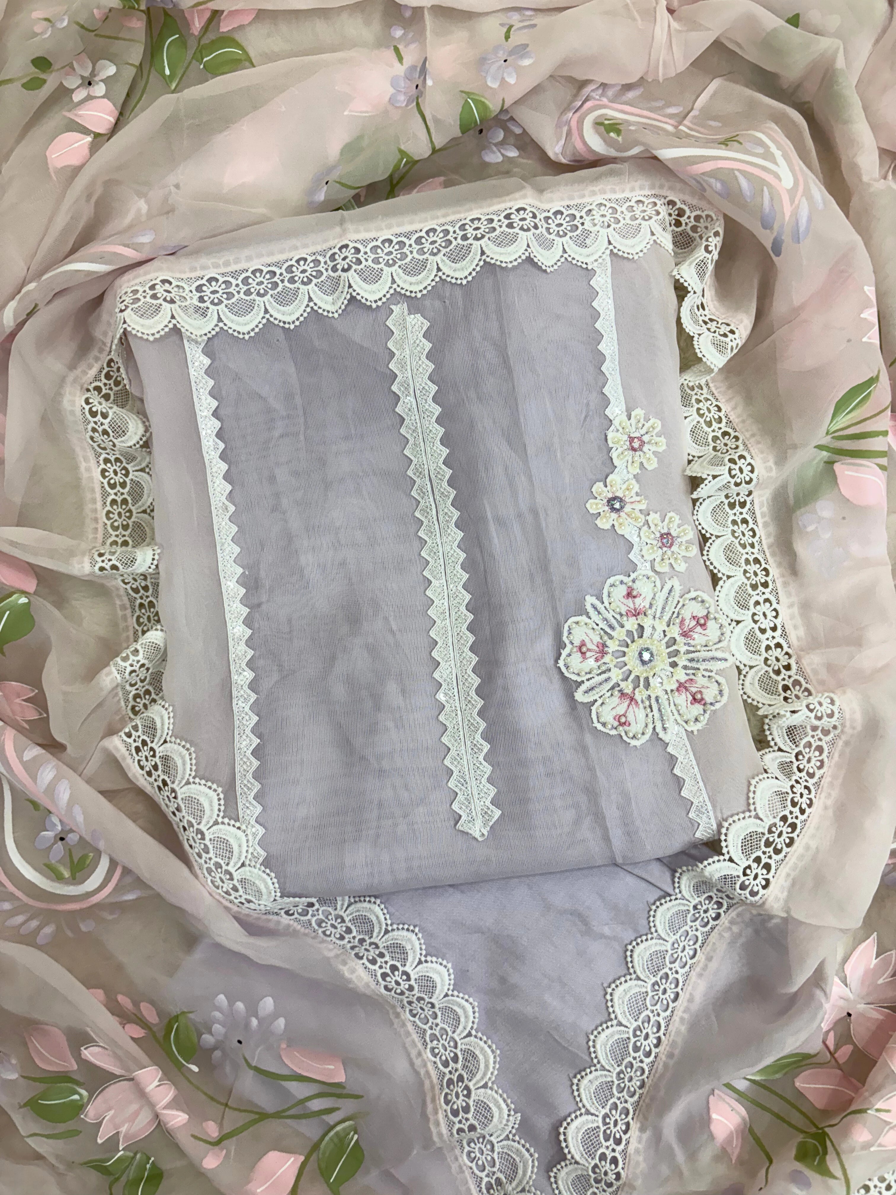 Lavender organza unstitched suit with white lace embroidery, cutwork border, and pastel floral printed organza dupatta – festive summer ethnic wear