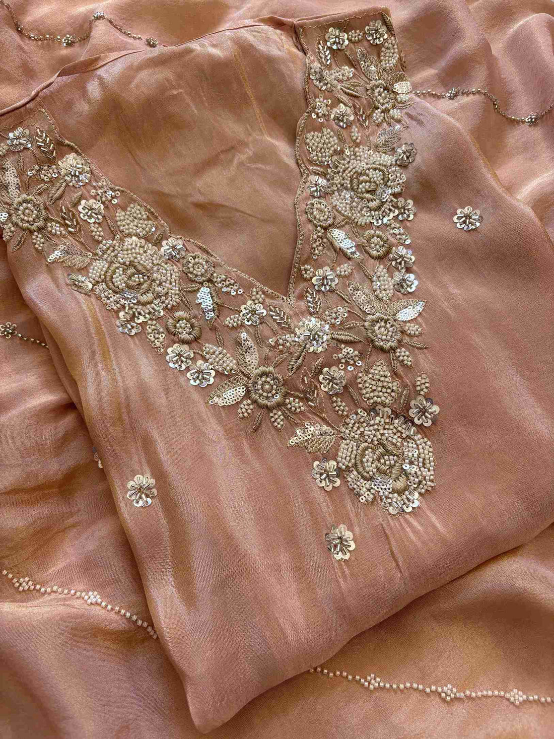 shimmer tissue party wear unstitched suit with dabka cutdana and sequence embellishments.