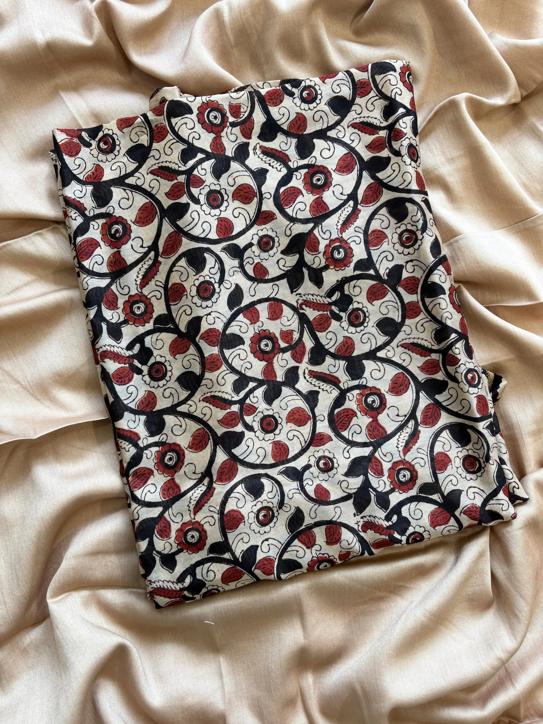 Maheshwari fabric suit with Kalamkari floral print in black, ivory, and maroon tones, featuring traditional hand-block designs and striped dupatta.