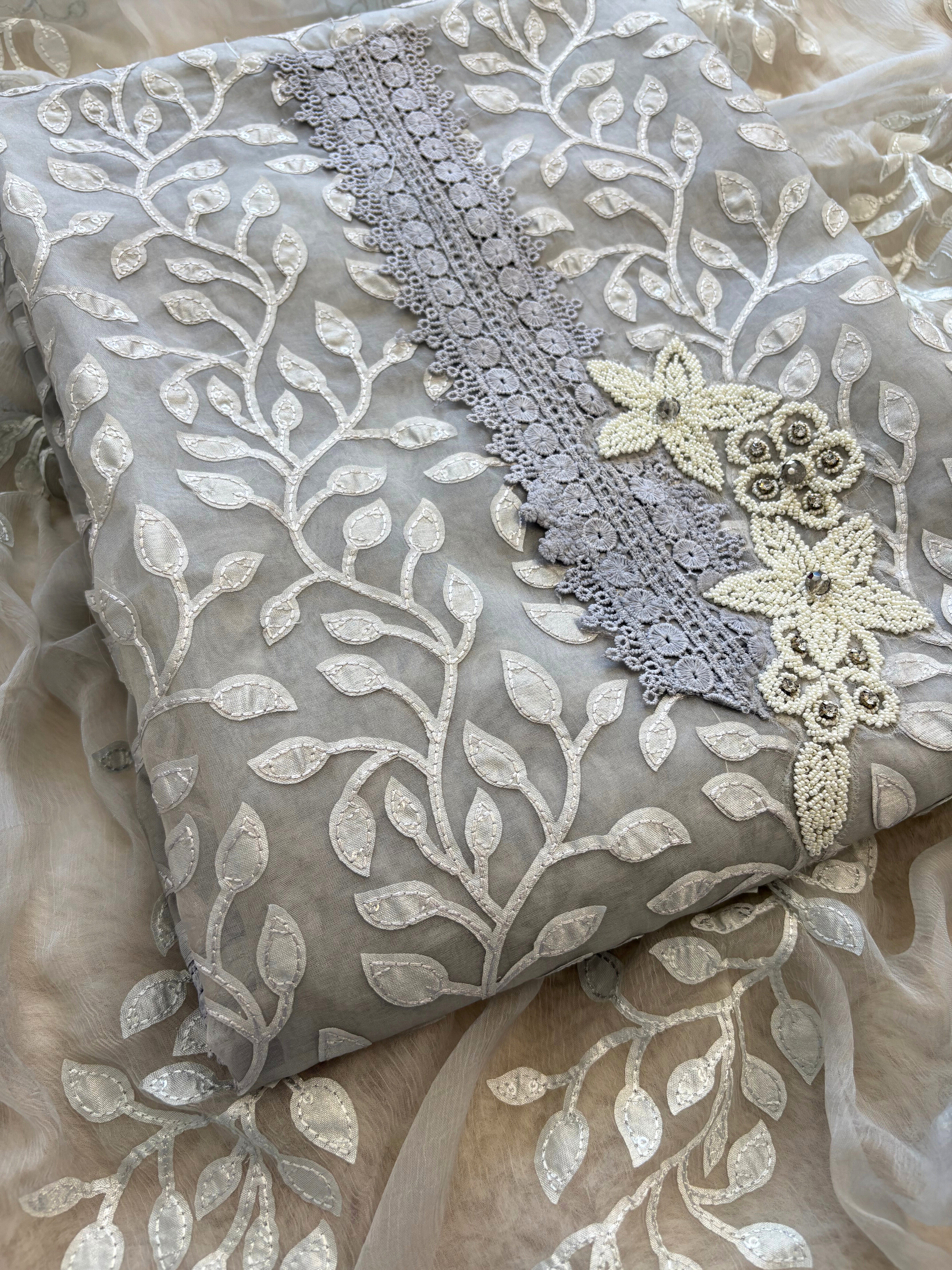 Silver grey organza suit with applique embroidery and moti bead embellishments, paired with embroidered organza dupatta.