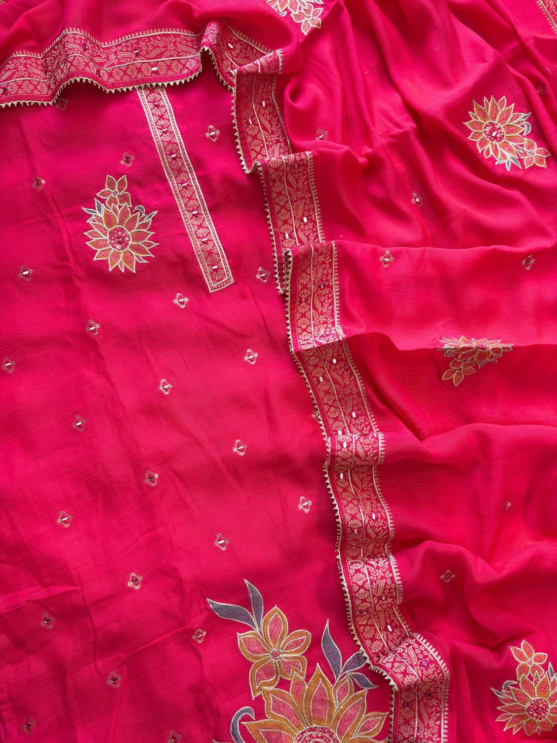 Pink linen suit with mirror work embroidery and appliqué floral dupatta.