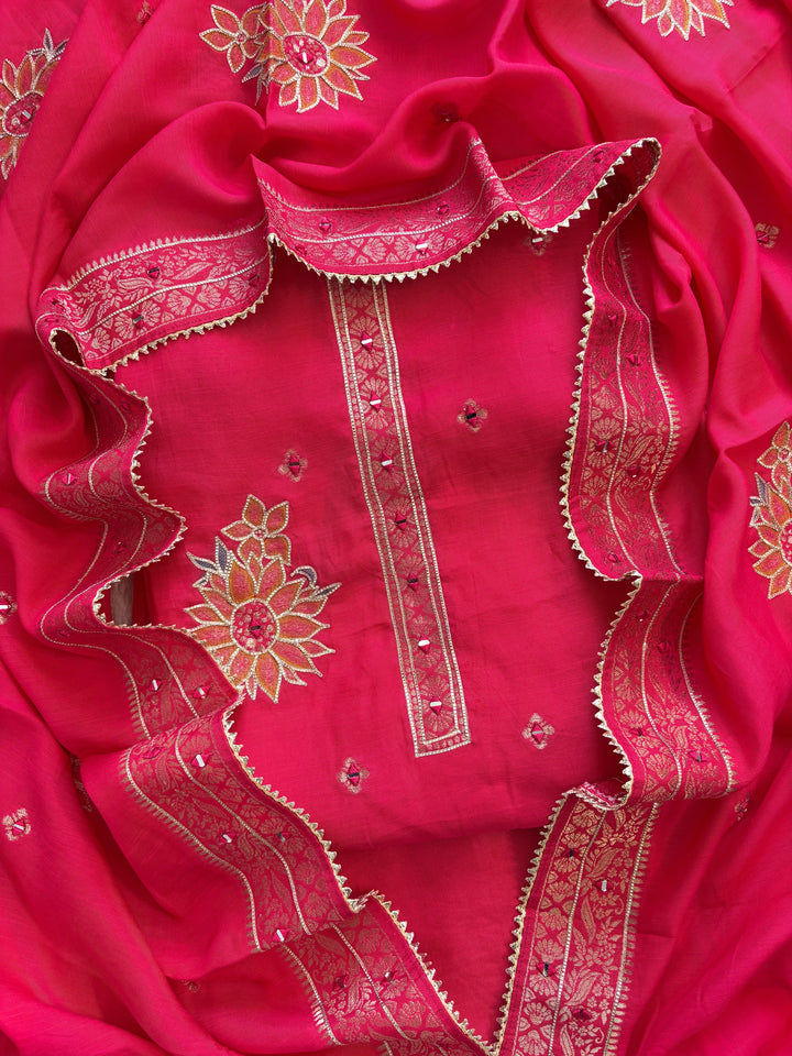 Pink linen suit with mirror work embroidery and applique floral dupatta.