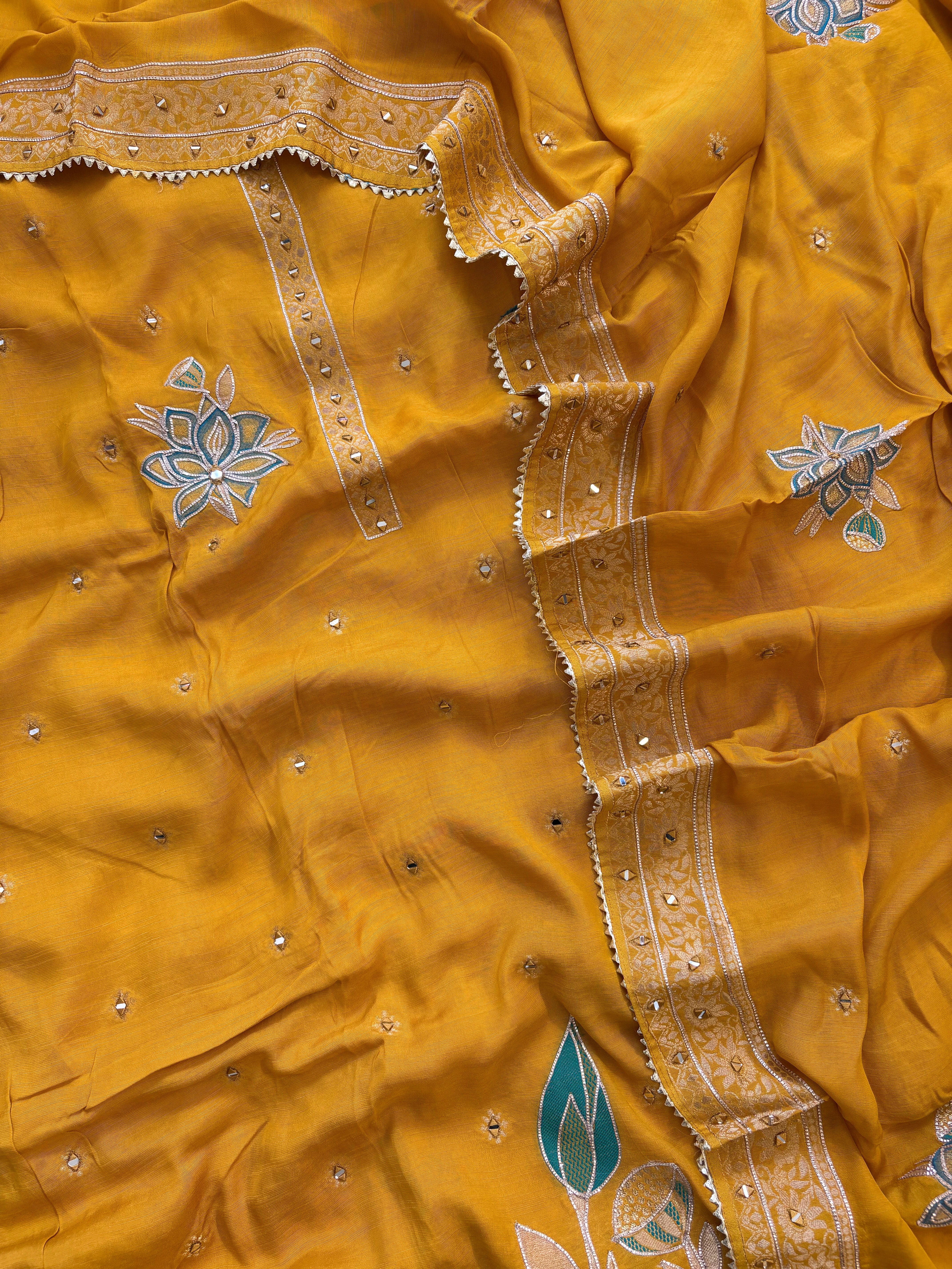 Mustard yellow linen suit with mirror work embroidery and applique floral dupatta.