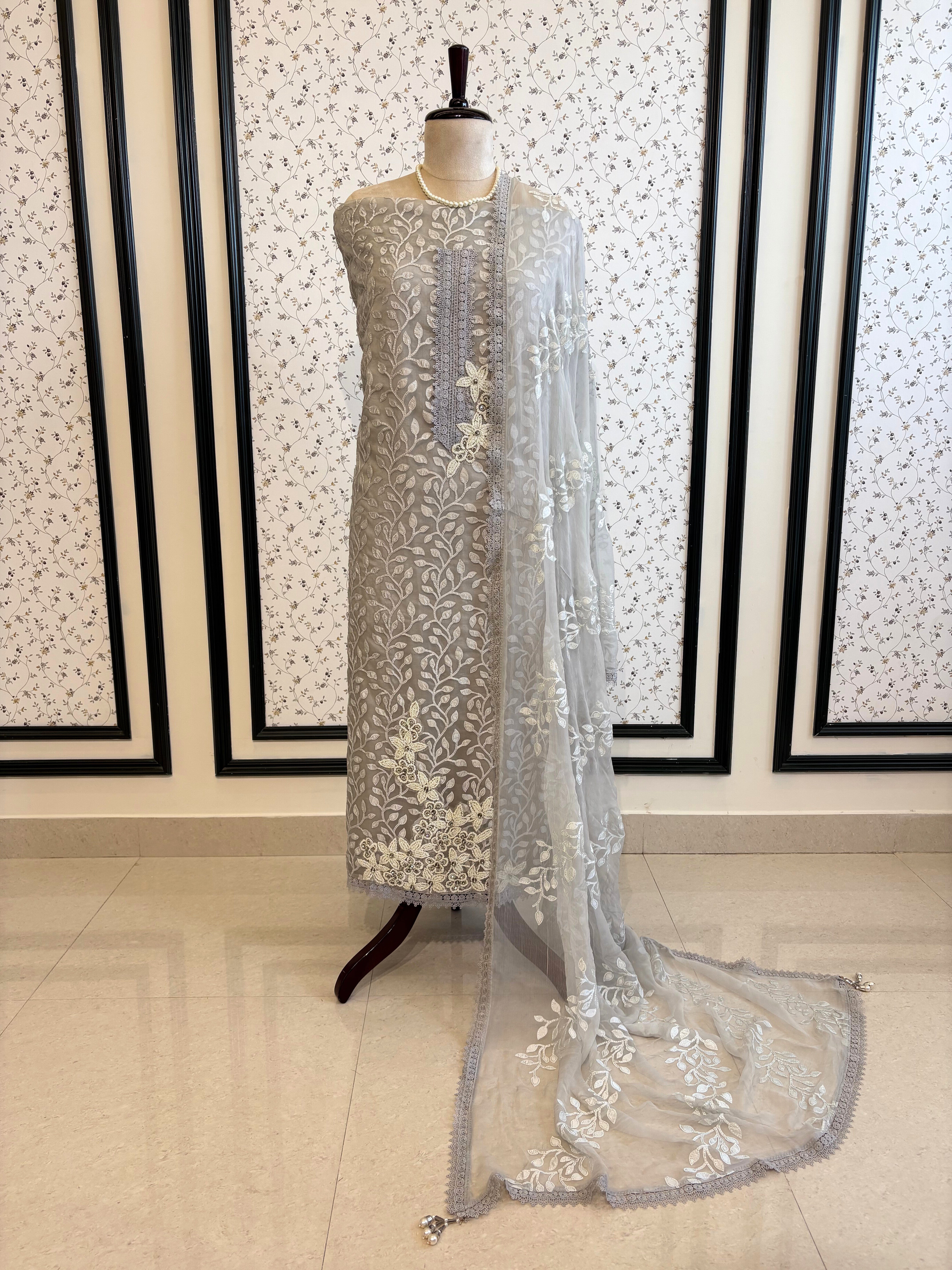 Silver grey organza suit with applique embroidery and moti bead embellishments, paired with embroidered organza dupatta.
