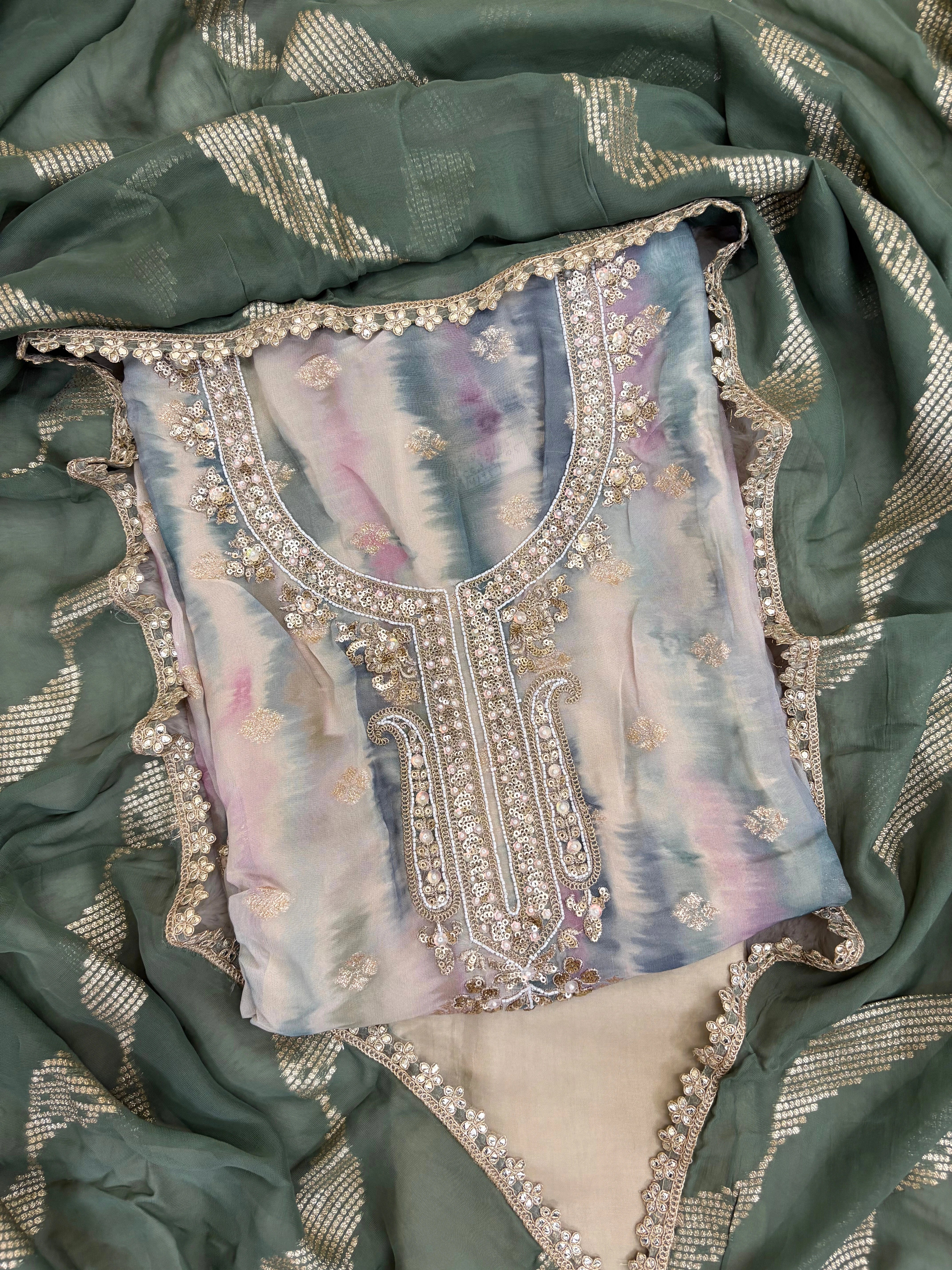 Pastel green organza suit with gold zari embroidery, pearl embellishments, and sequin work, paired with an banarisi jacquard dupatta for weddings and festive occasions.