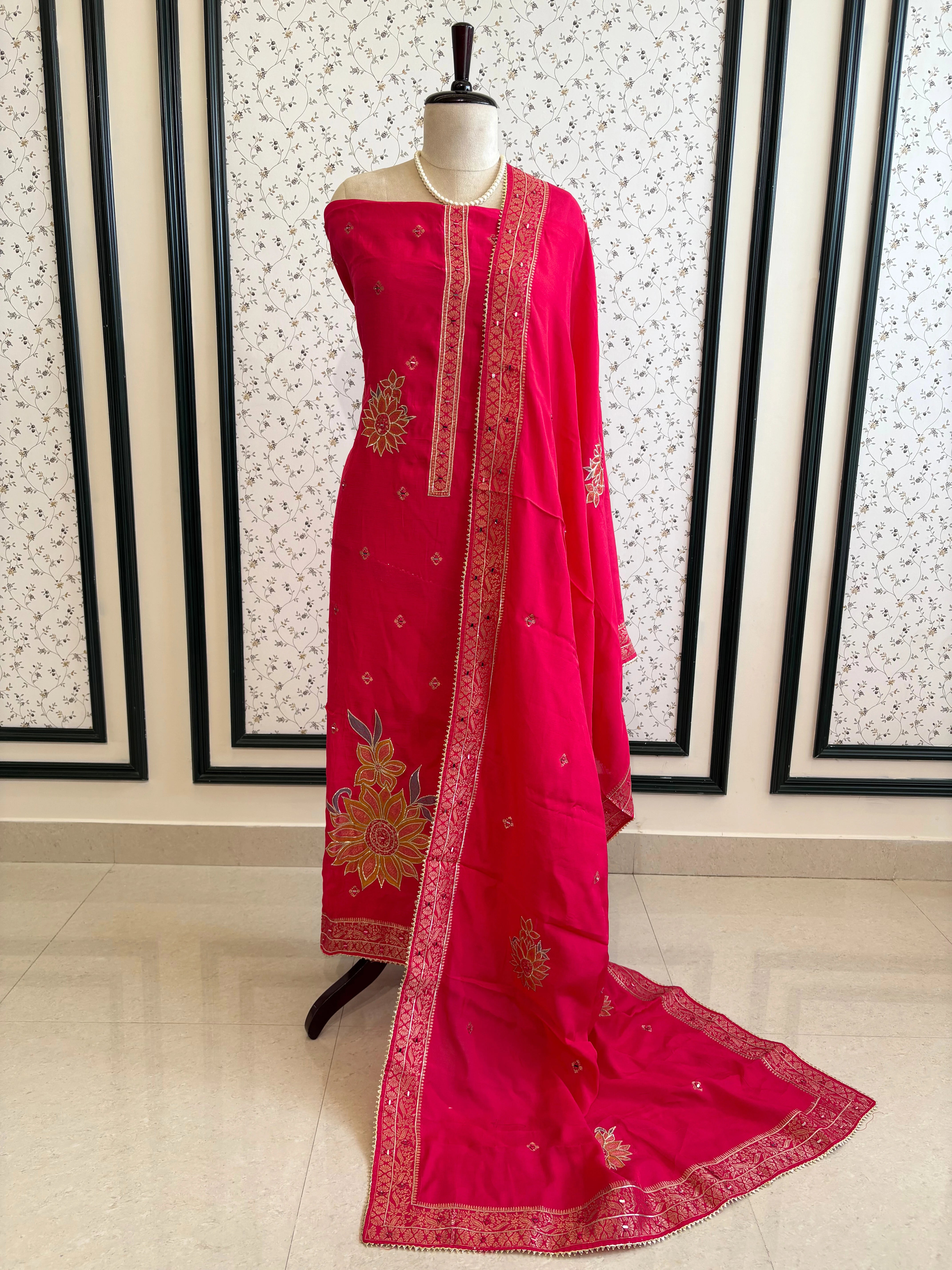 Pink linen suit with mirror work embroidery and applique floral dupatta.