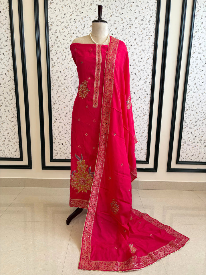 Pink linen suit with mirror work embroidery and applique floral dupatta.