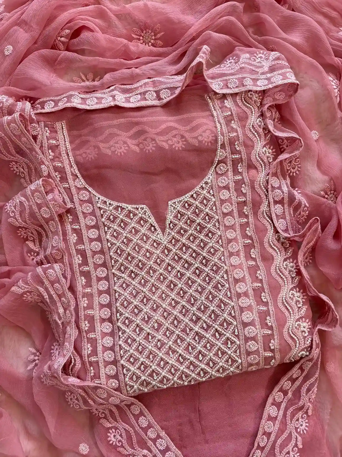 Powder pink georgette suit with moti highlighting and chiffon dupatta – embroidered festive ethnic wear for weddings and formal occasions.