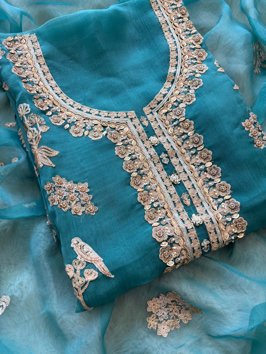 organza unstitched suit with zari work and parrot figure