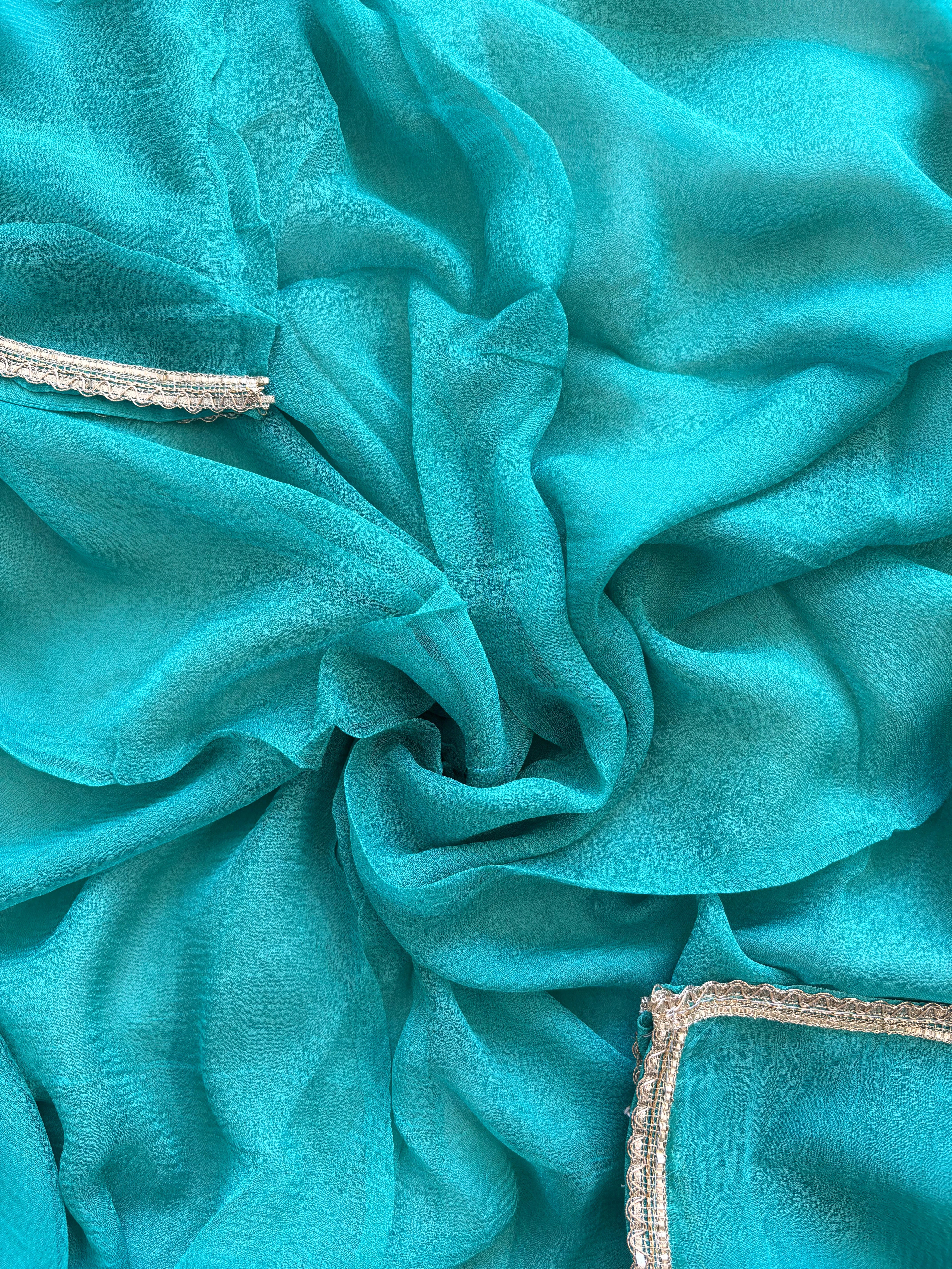 Blue Shimmer organza bandhani suit with ombre effect and chiffon dupatta with lace border.