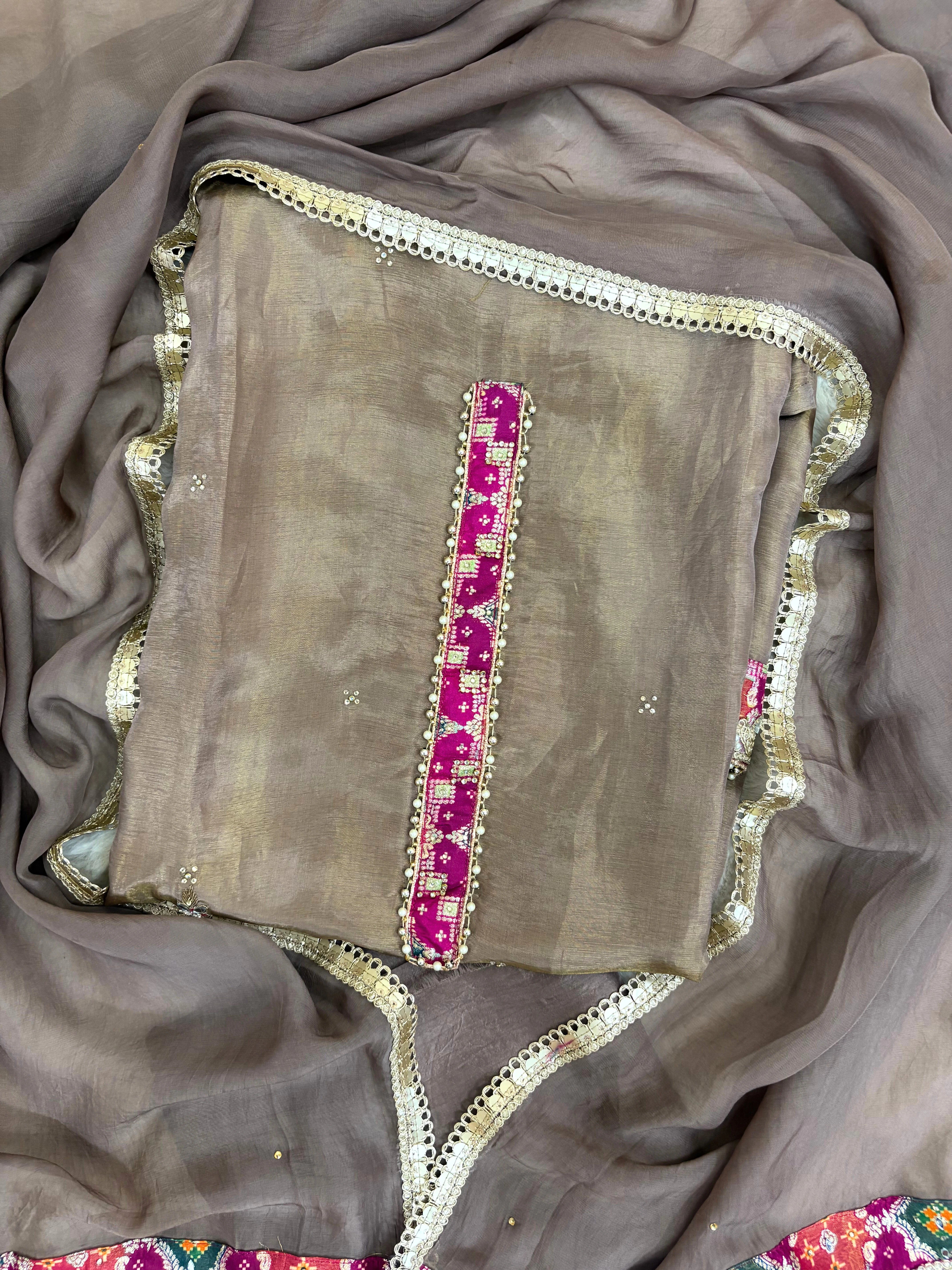 Taupe brown organza unstitched suit with mirror work, sequin embroidery, and magenta contrast neckline patch, paired with mirror lace organza dupatta – festive ethnic wear