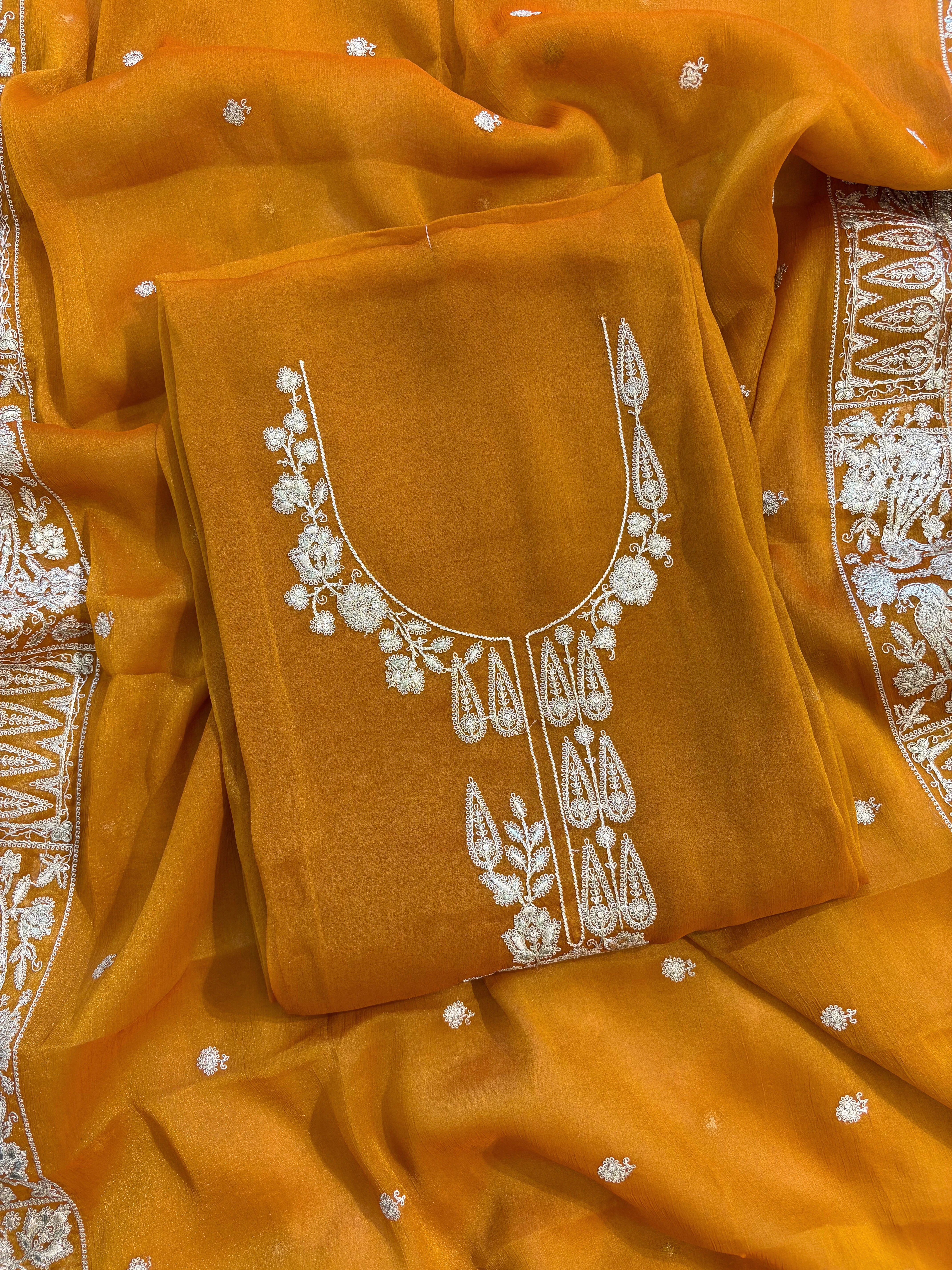 Mustard Yellow organza unstitched suit with golden zari embroidery and embroidered dupatta, ideal for weddings and festive celebrations.
