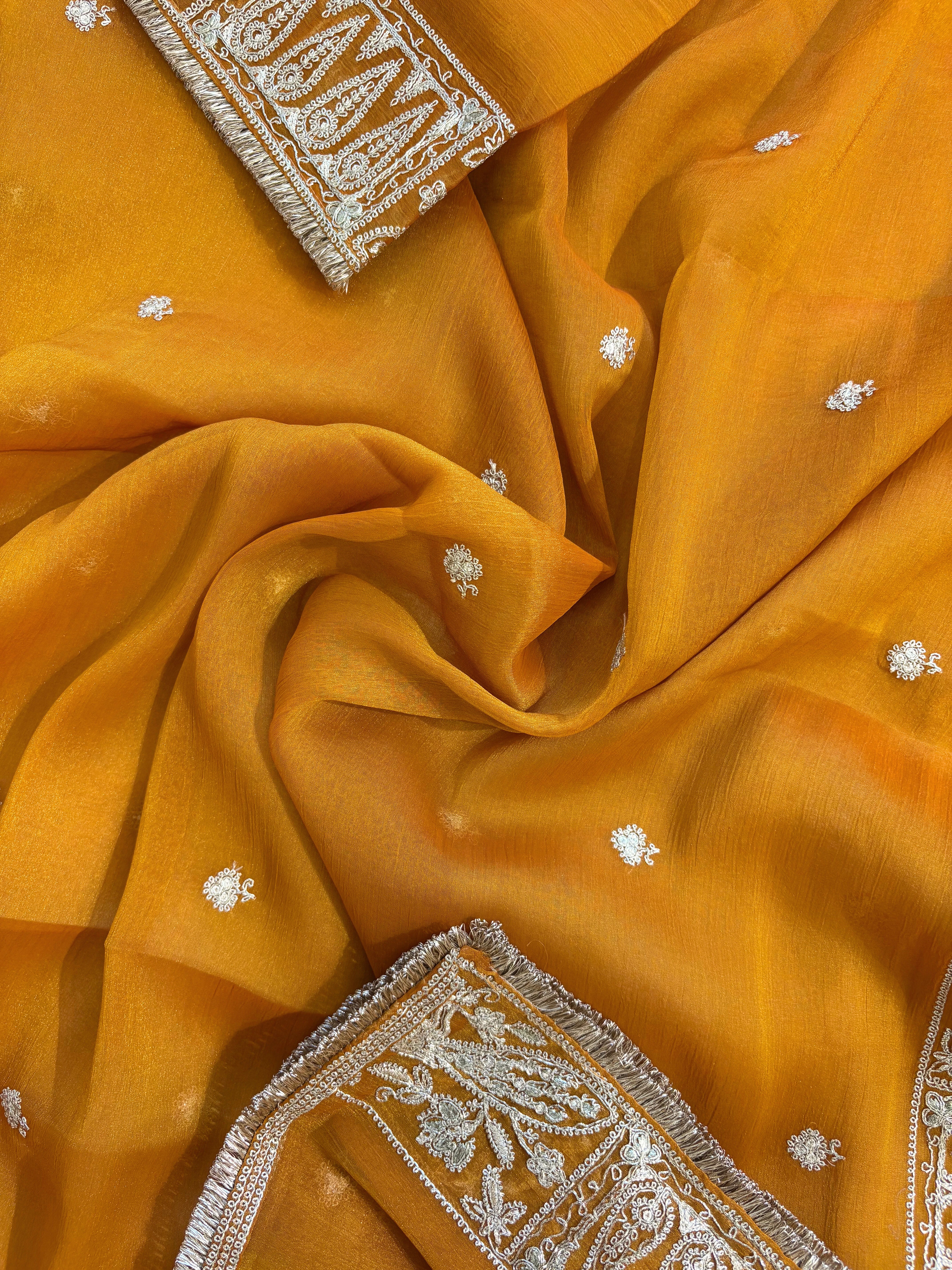 Mustard Yellow organza unstitched suit with golden zari embroidery and embroidered dupatta, ideal for weddings and festive celebrations.