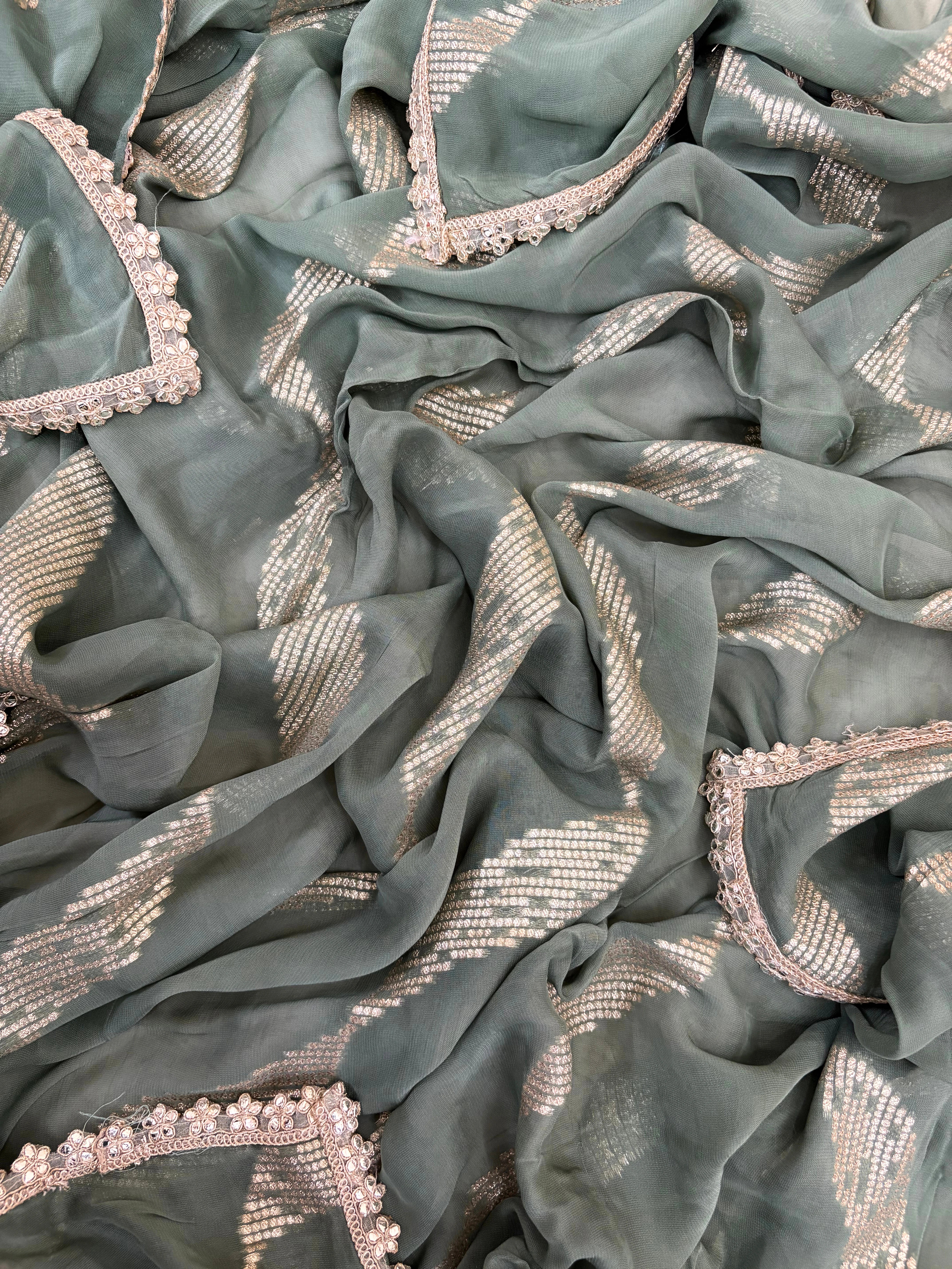 Pastel green organza suit with gold zari embroidery, pearl embellishments, and sequin work, paired with an banarisi jacquard dupatta for weddings and festive occasions.