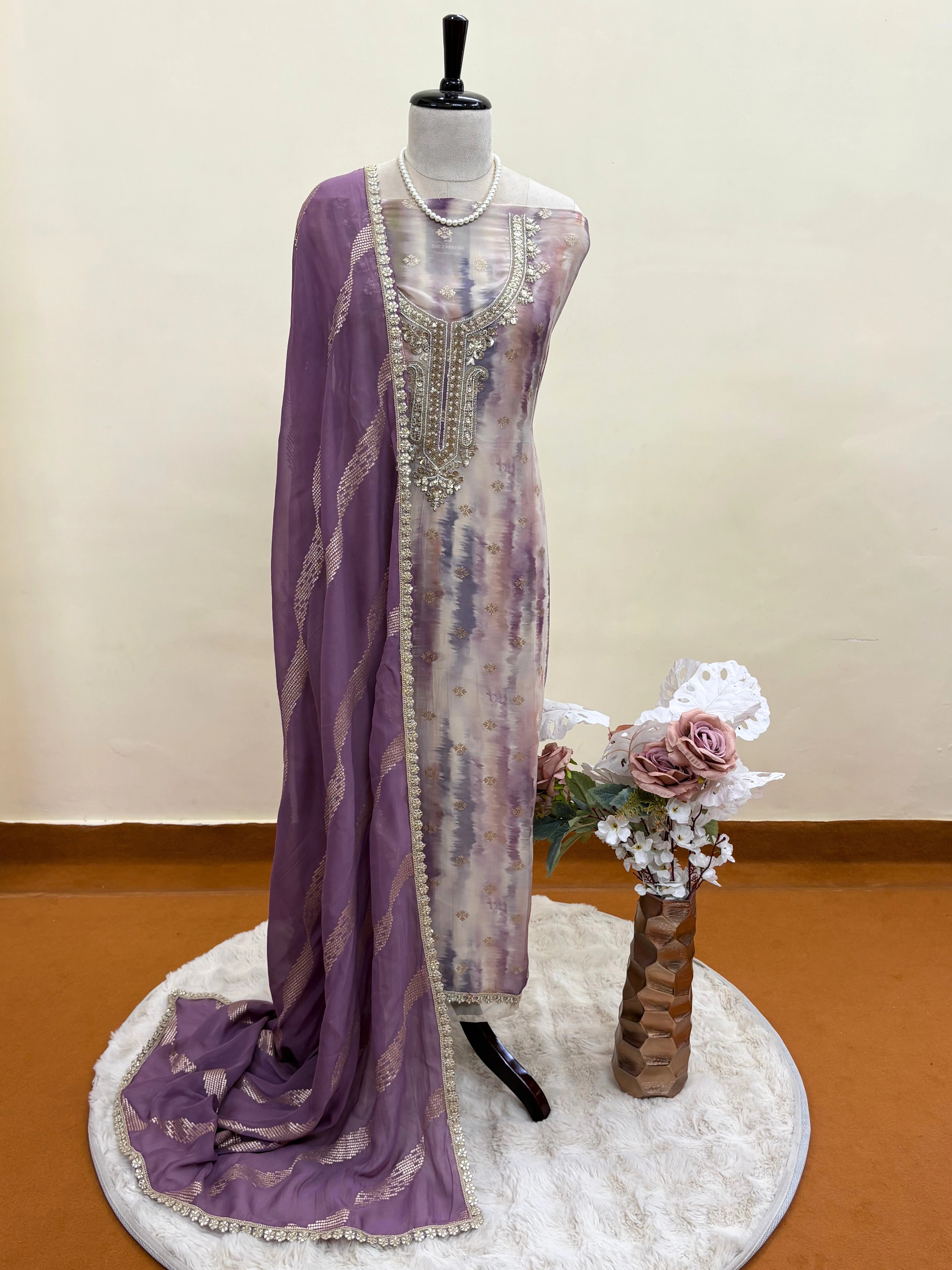 Pastel organza suit with silver zari embroidery, pearl embellishments, and sequin work, paired with an banarisi jacquard dupatta for weddings and festive occasions.