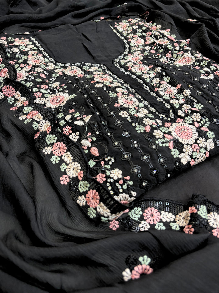 Black chiffon suit with intricate pastel floral embroidery, sequin accents, and a matching embroidered dupatta, ideal for weddings and festive occasions.