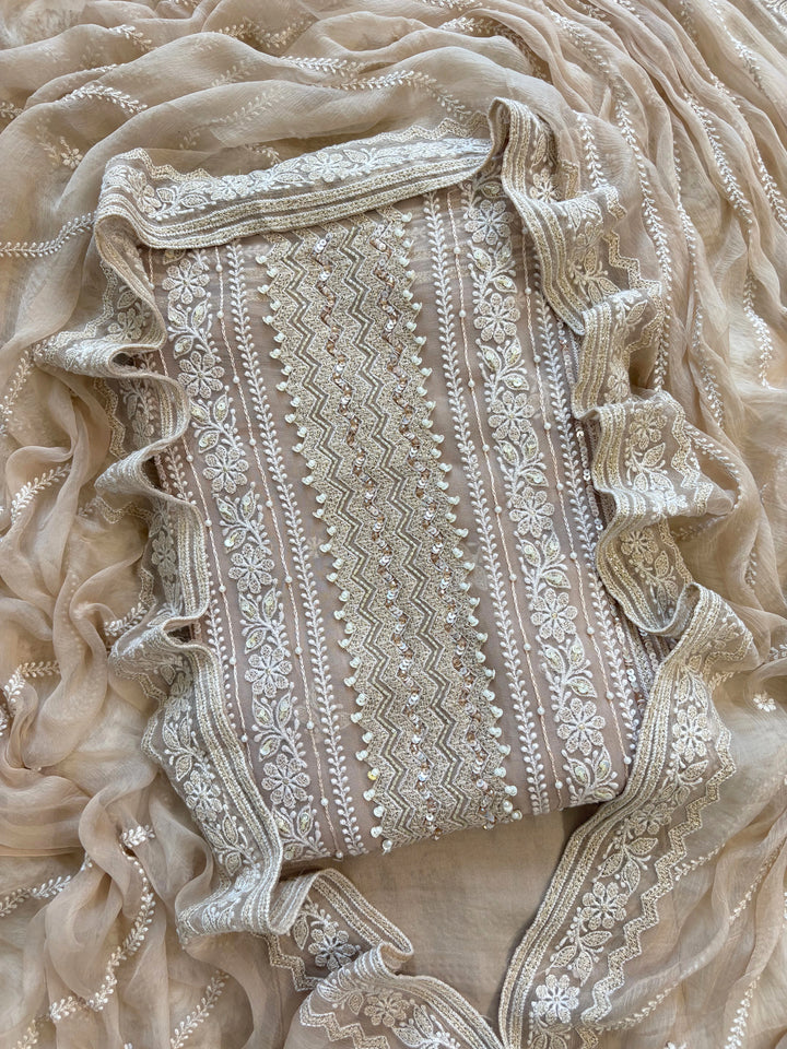 Nude georgette chikankari suit with moti and sequin highlighting, paired with chiffon chikankari dupatta.