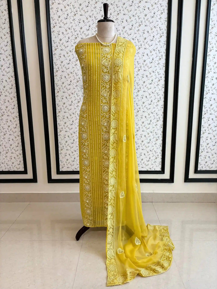 yellow georgette chikankari unstitched suit with moti and sequence embellishments