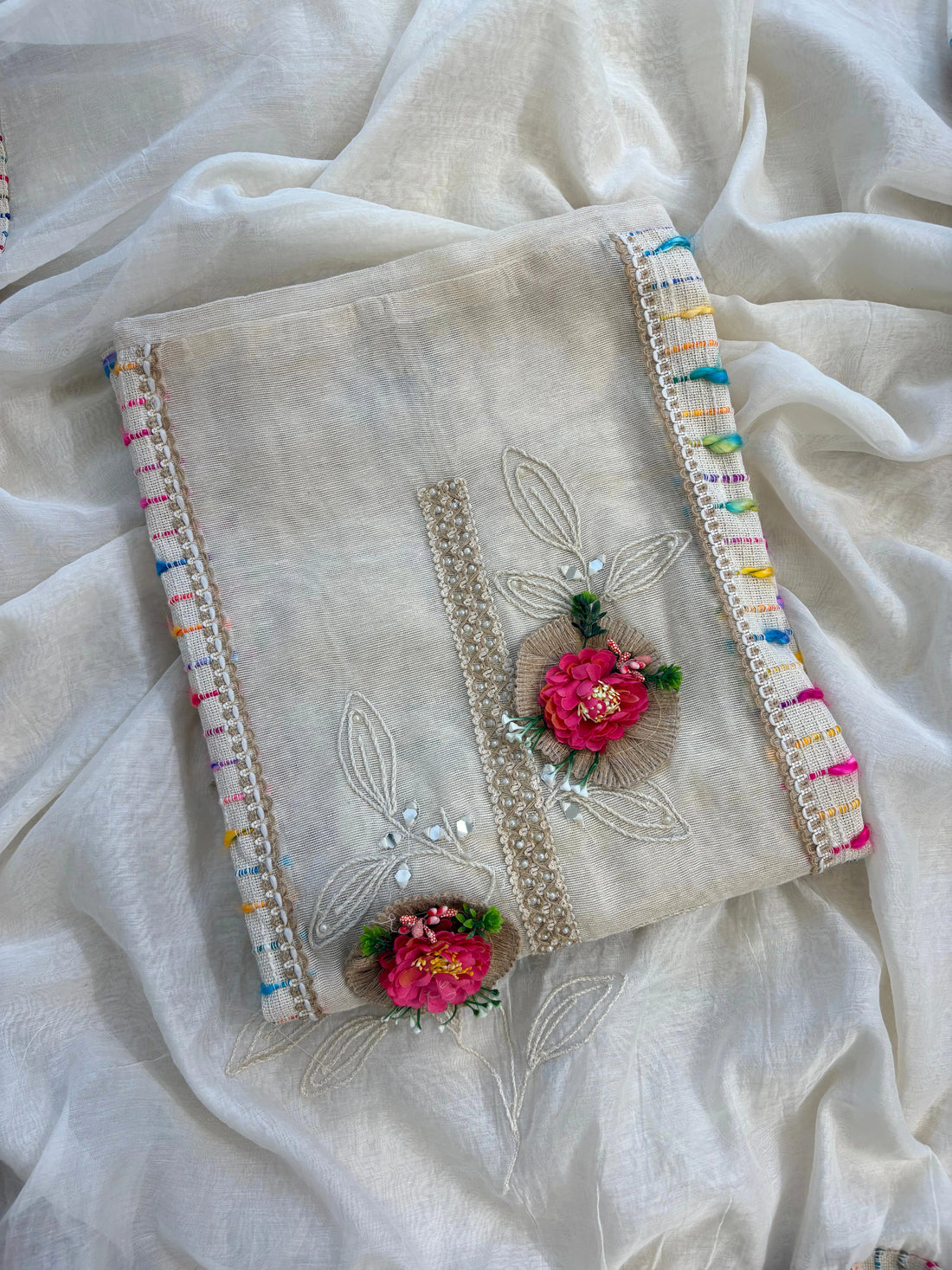 Ivory jute cotton suit with 3D floral embellishments and embroidered dupatta with multicolor thread border.