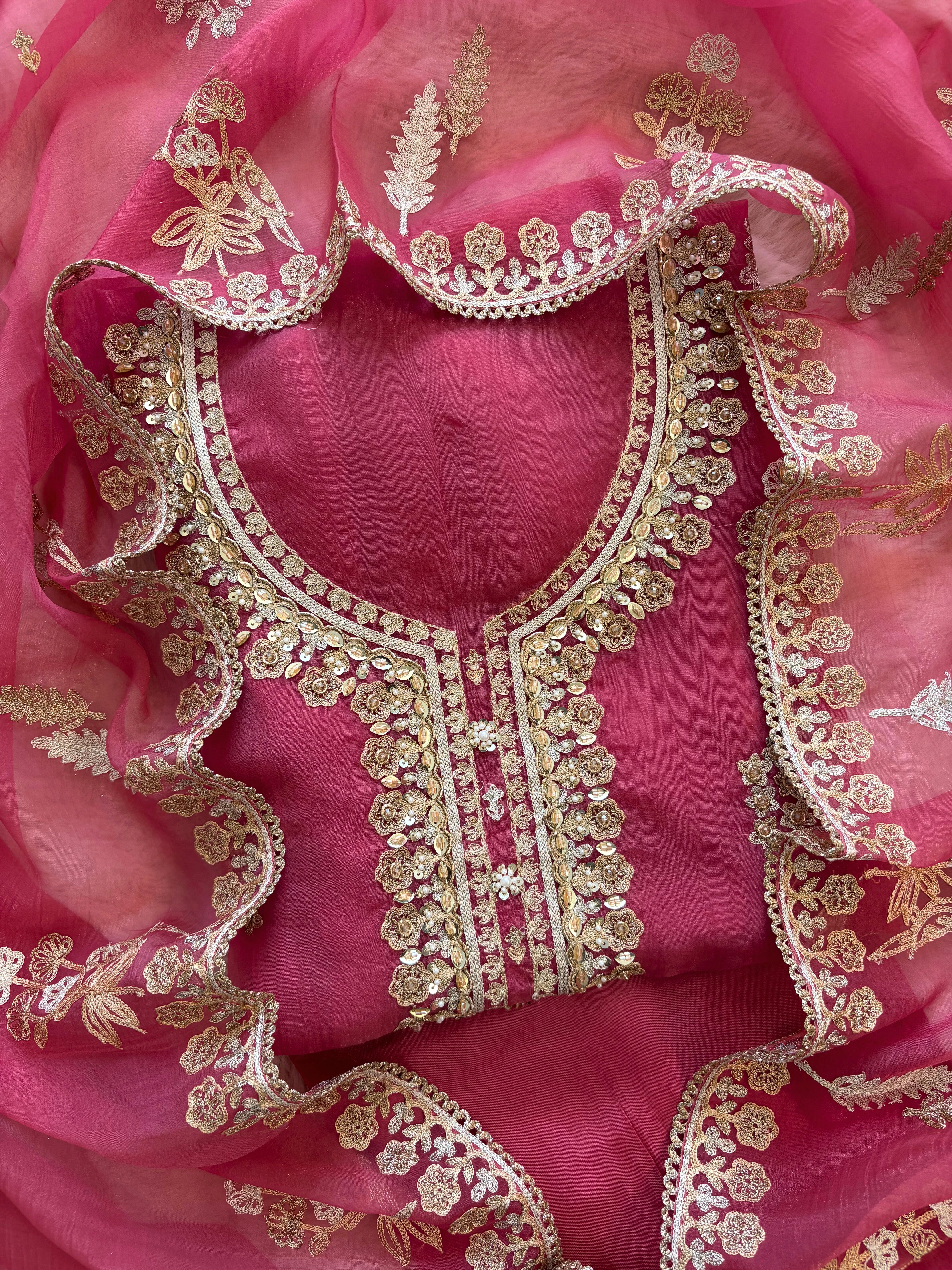 pink organza unstitched suit with zari work and parrot figure
