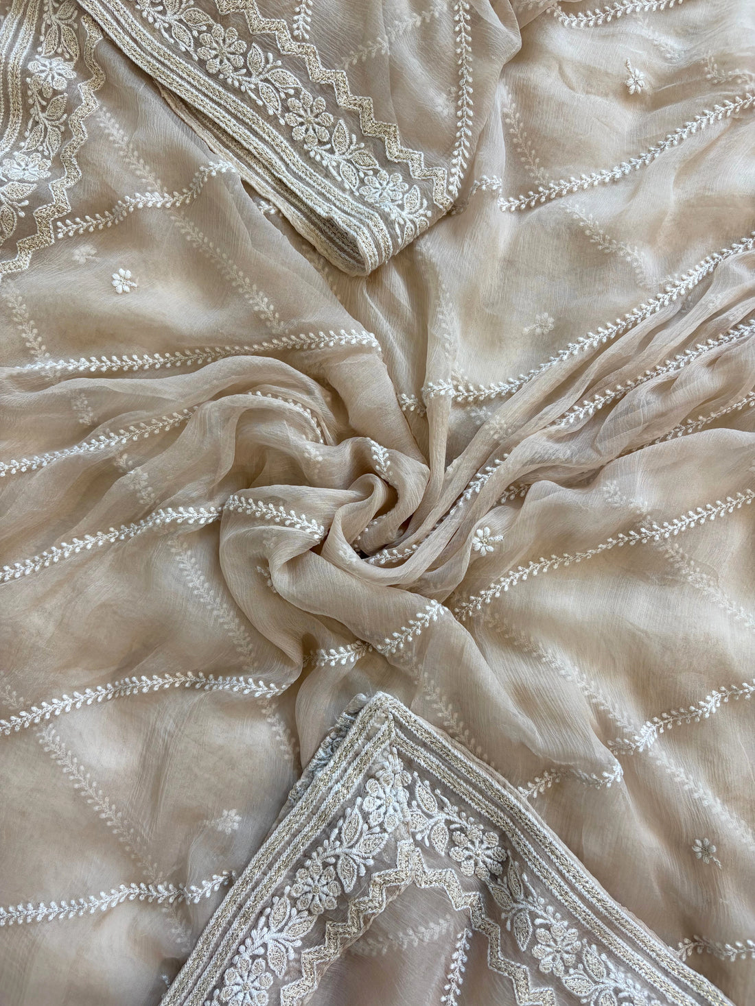 Nude georgette chikankari suit with moti and sequin highlighting, paired with chiffon chikankari dupatta.