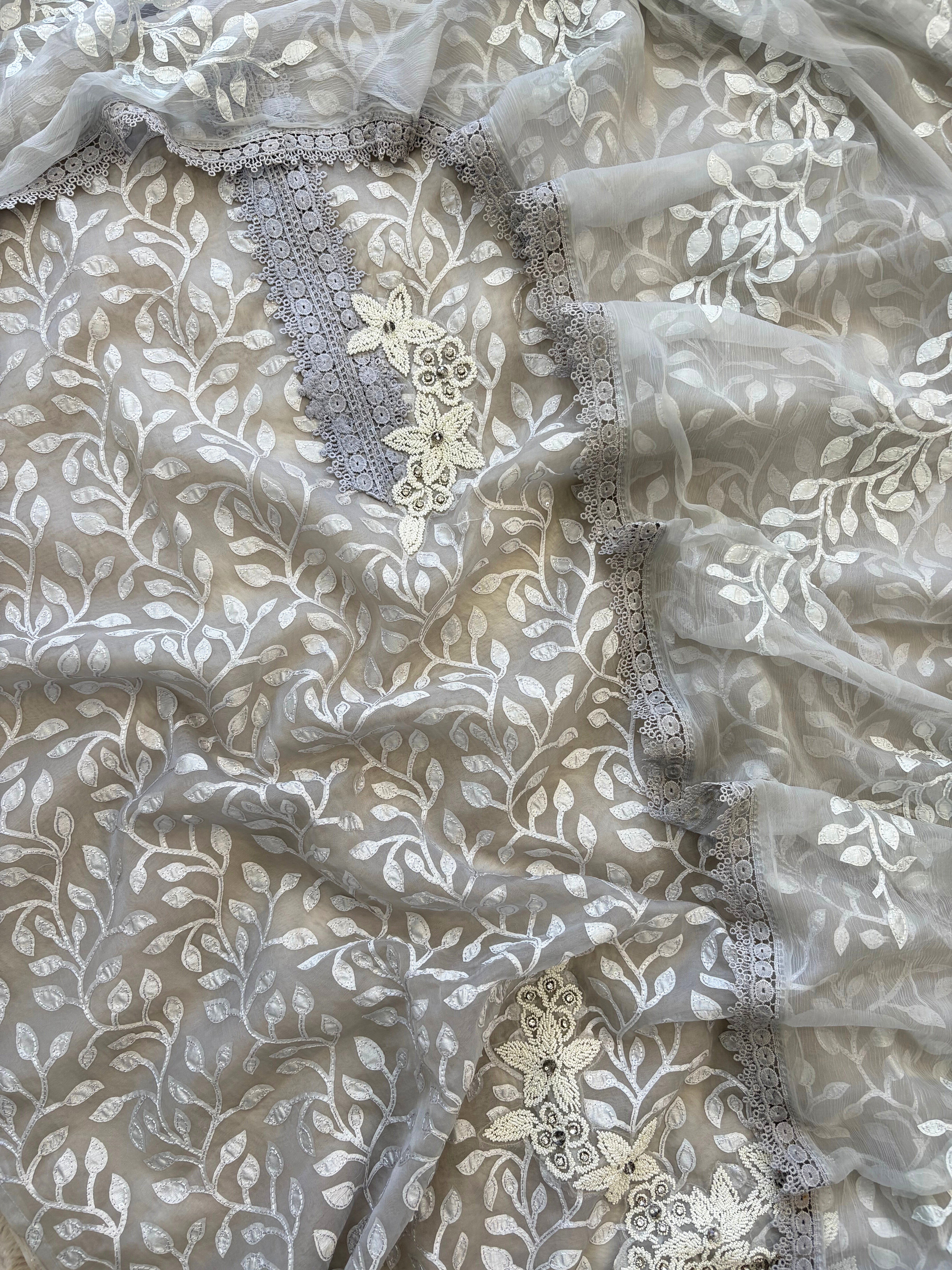 Silver grey organza suit with applique embroidery and moti bead embellishments, paired with embroidered organza dupatta.