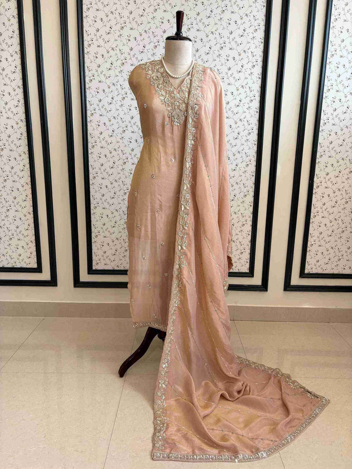 shimmer tissue party wear unstitched suit with dabka cutdana and sequence embellishments.