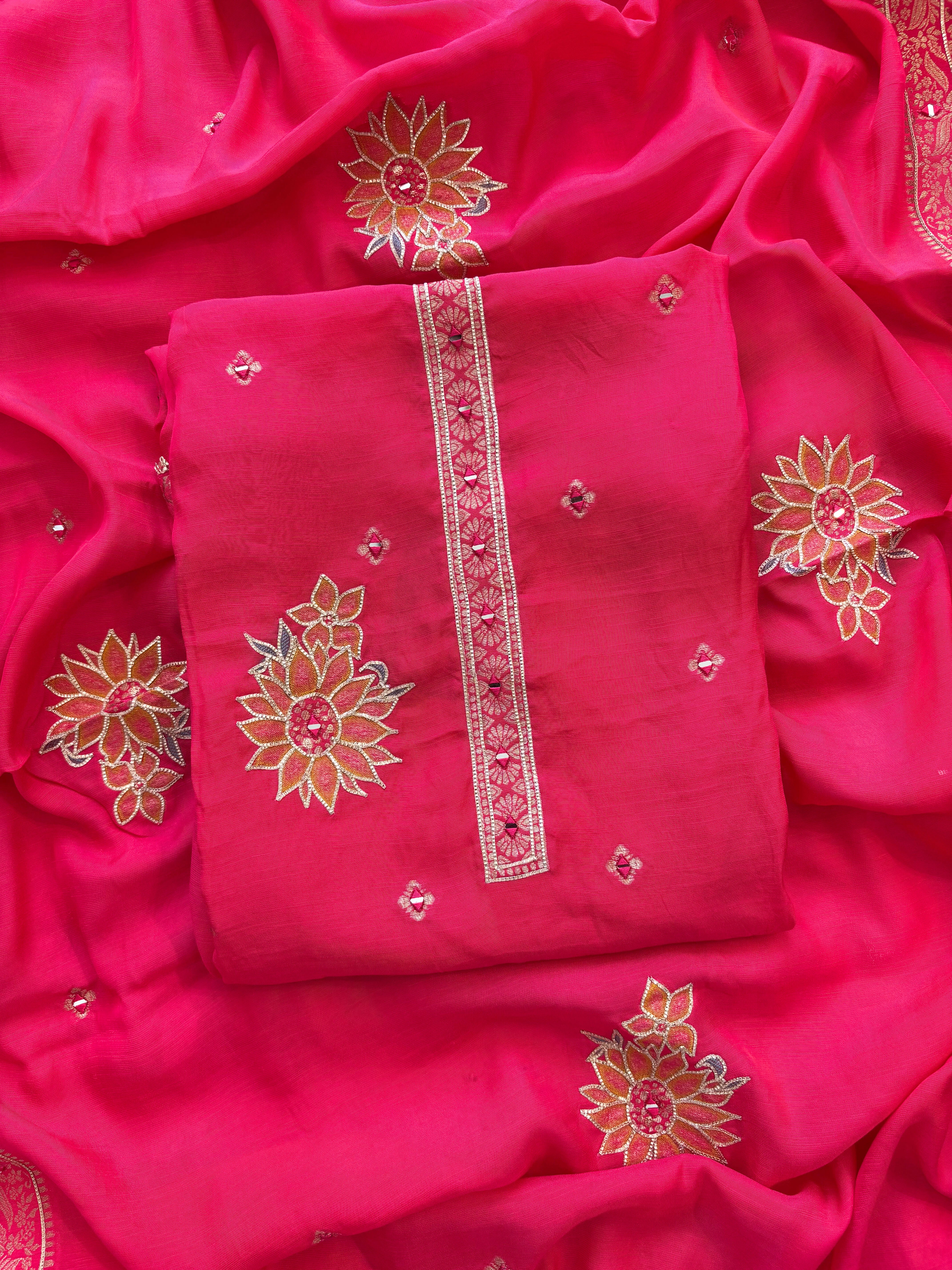 Pink linen suit with mirror work embroidery and applique floral dupatta.