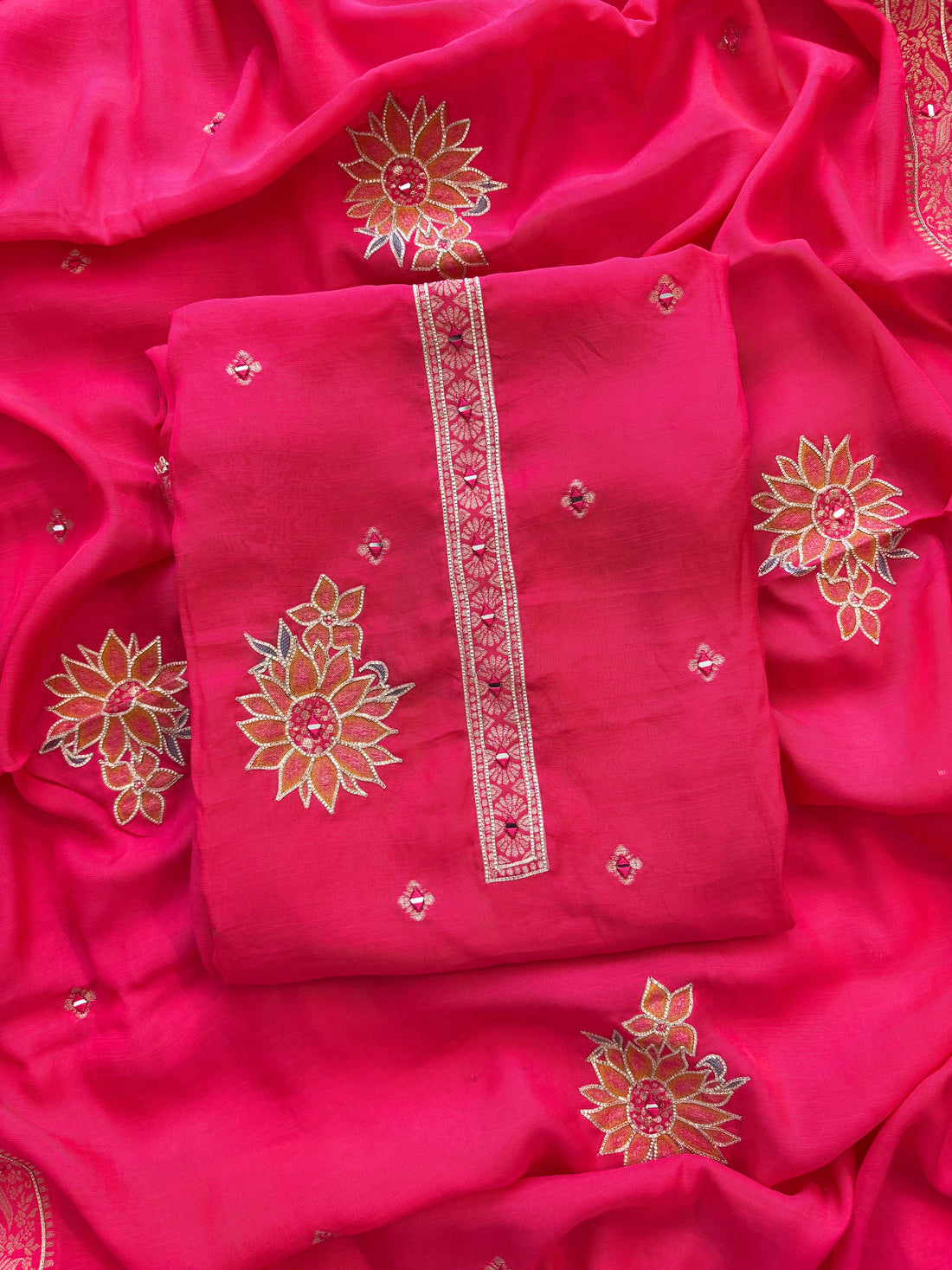 Pink linen suit with mirror work embroidery and applique floral dupatta.