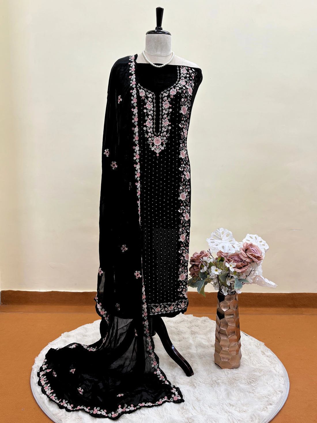 Black chiffon suit with intricate pastel floral embroidery, sequin accents, and a matching embroidered dupatta, ideal for weddings and festive occasions.
