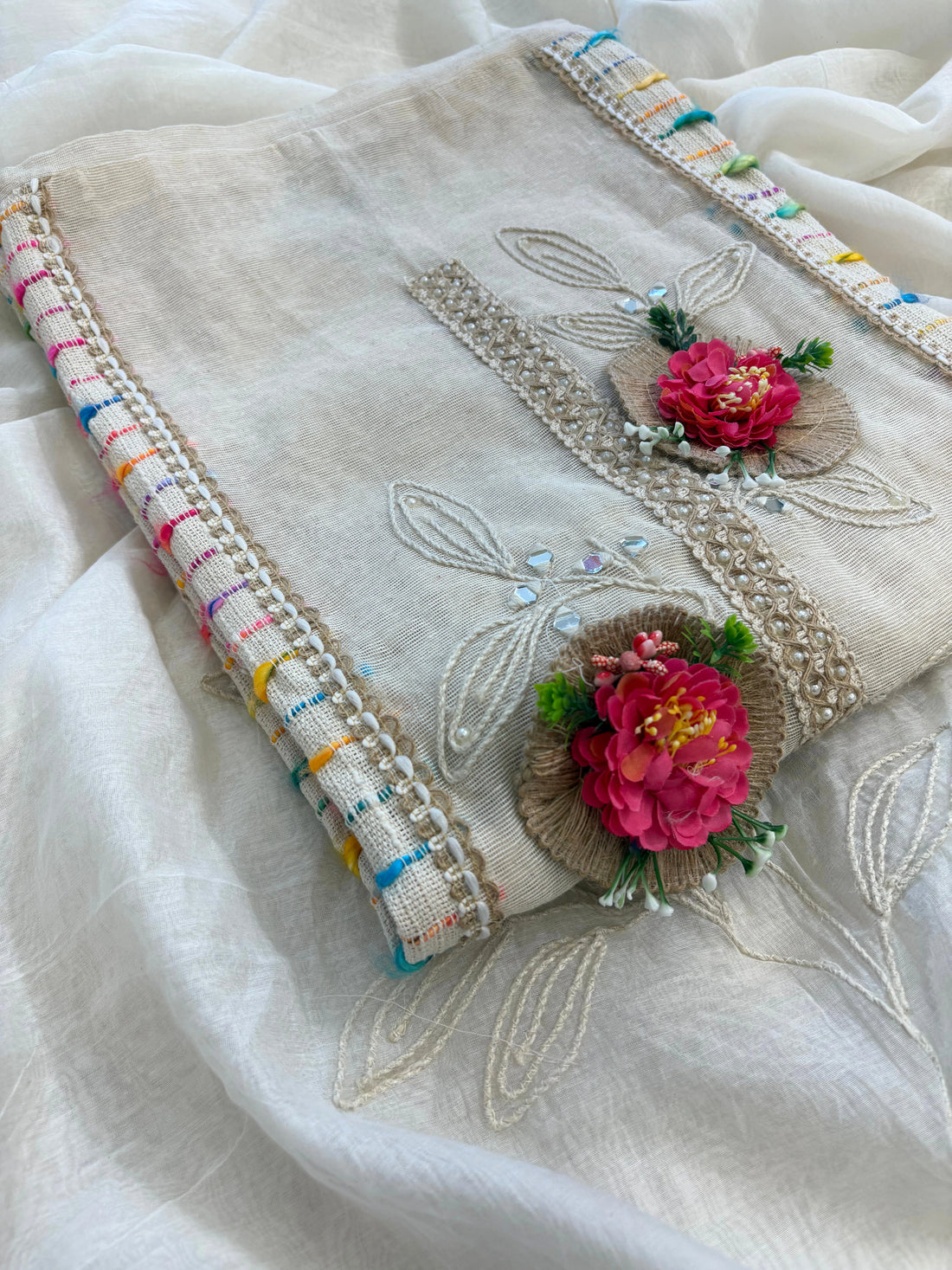 Ivory jute cotton suit with 3D floral embellishments and embroidered dupatta with multicolor thread border.