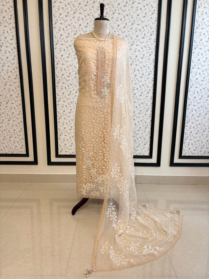 Peach organza suit with applique embroidery and moti bead embellishments, paired with embroidered organza dupatta.