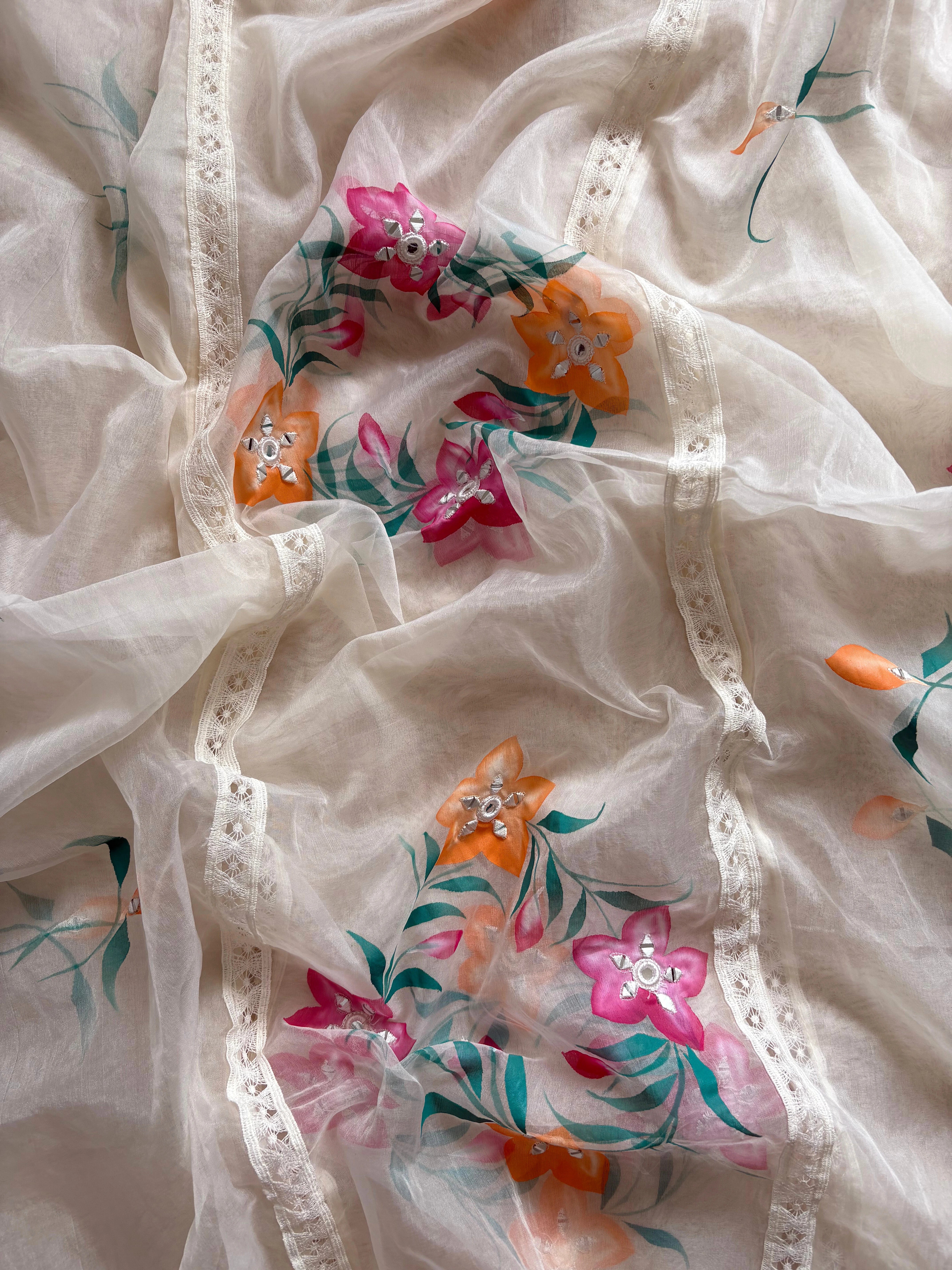 Ivory linen suit with embroidered detailing and hand-painted floral organza dupatta, finished with lace border – unstitched ethnic wear set