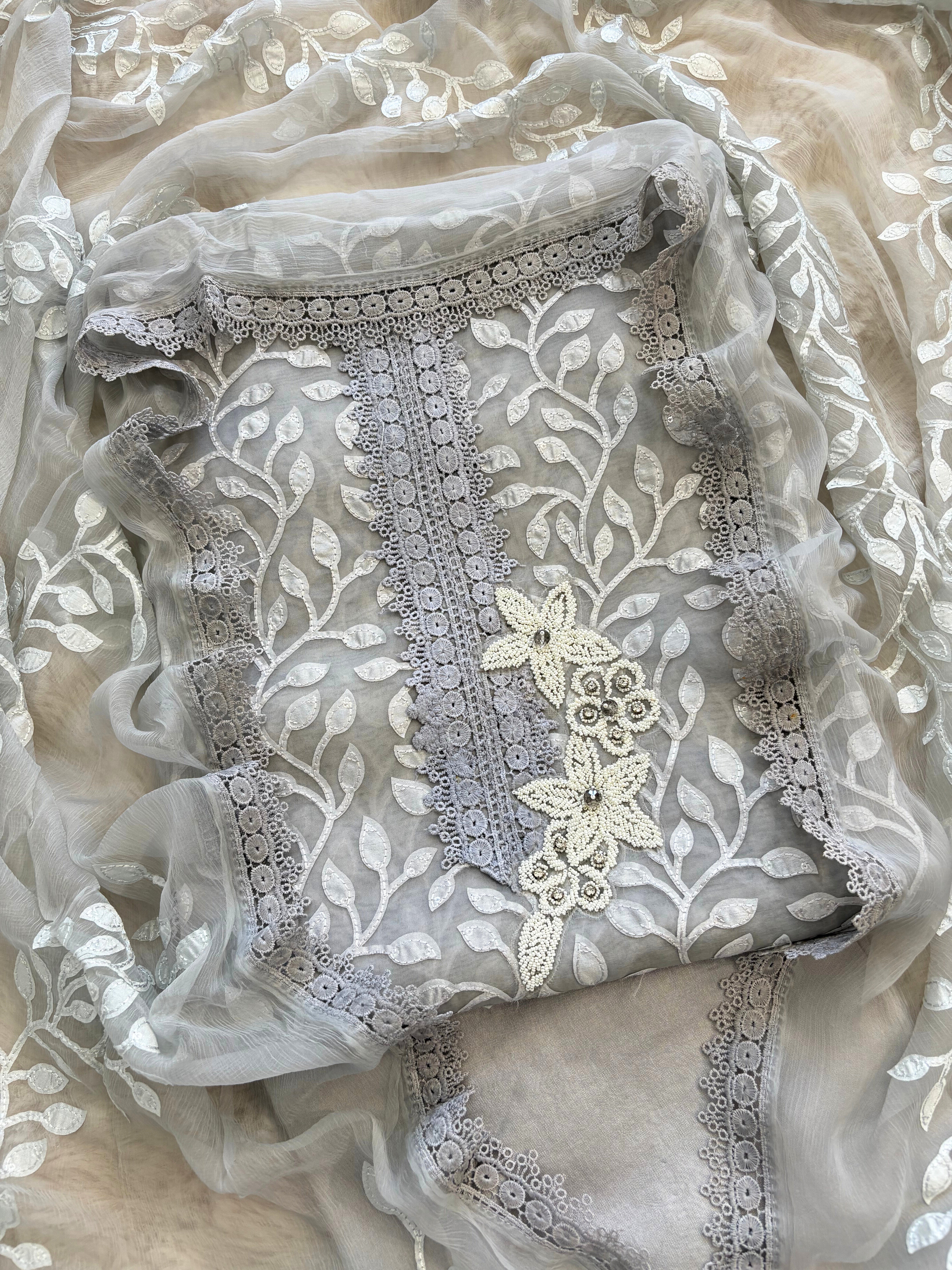 Silver grey organza suit with applique embroidery and moti bead embellishments, paired with embroidered organza dupatta.