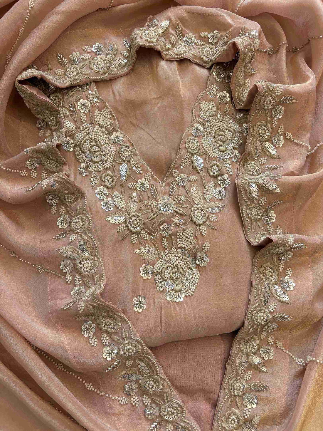 shimmer tissue party wear unstitched suit with dabka cutdana and sequence embellishments.