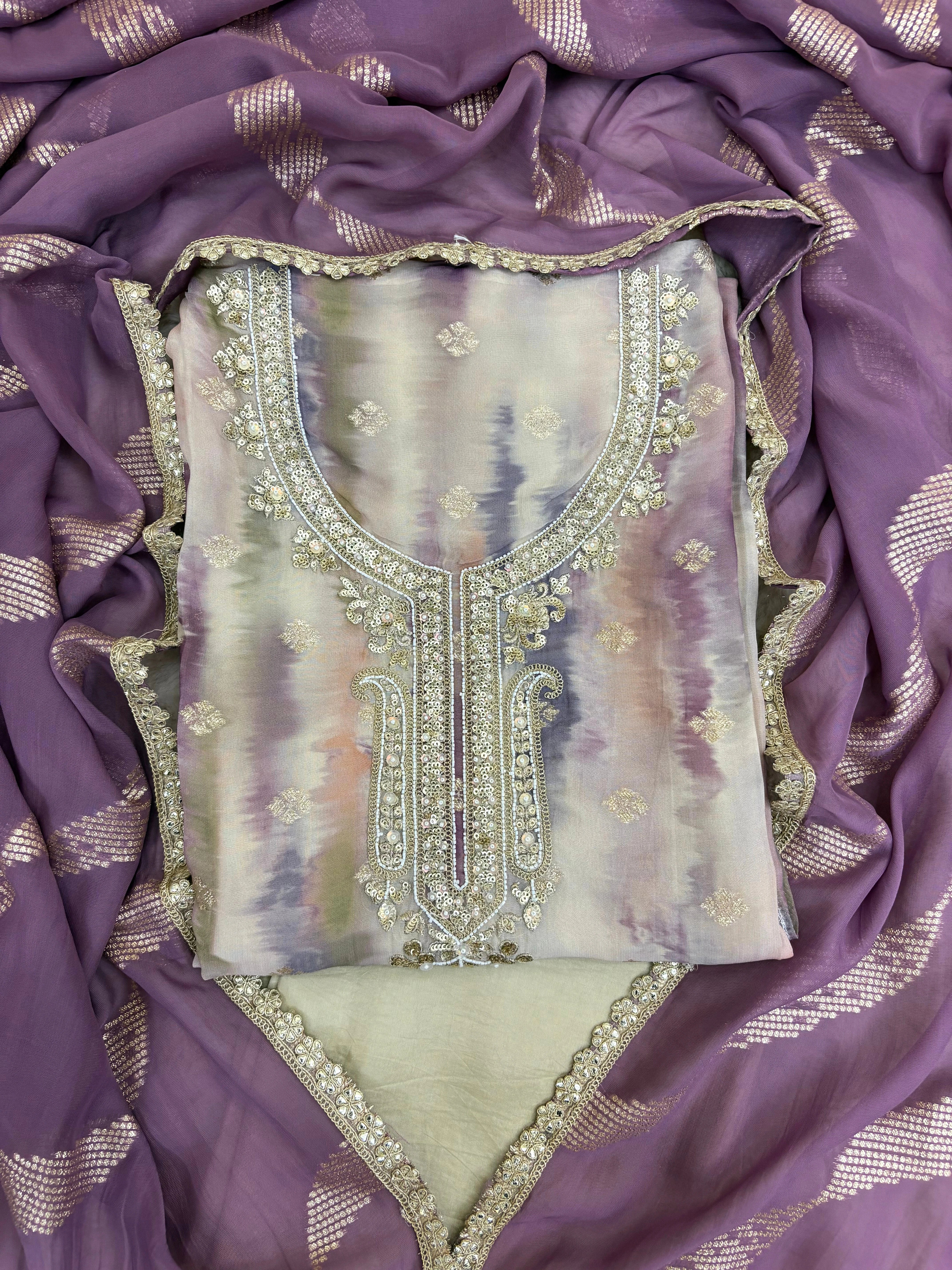 Pastel purple organza suit with silver zari embroidery, pearl embellishments, and sequin work, paired with an banarisi jacquard dupatta for weddings and festive occasions.