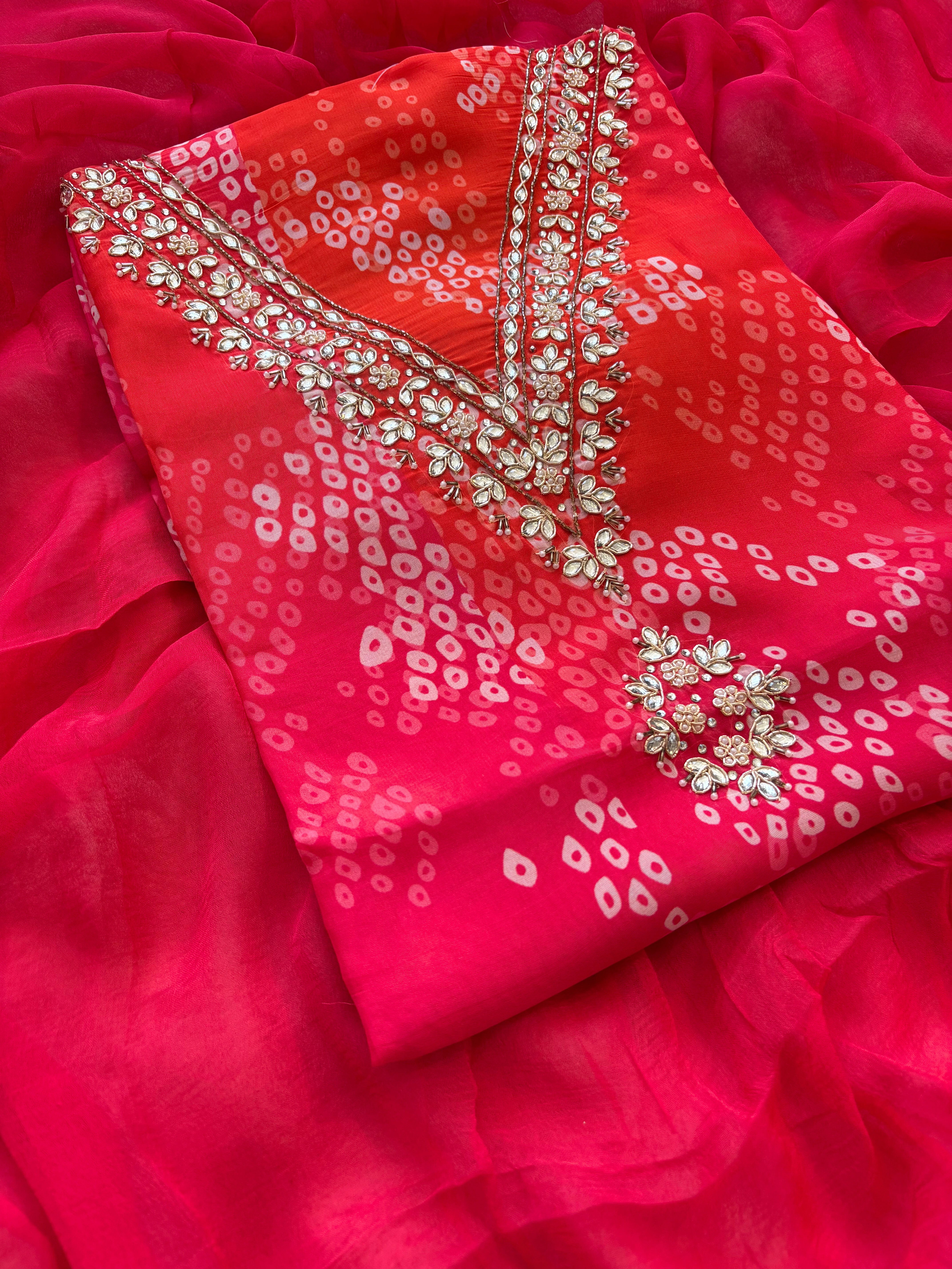 Red organza bandhani suit with ombre effect and chiffon dupatta with lace border.