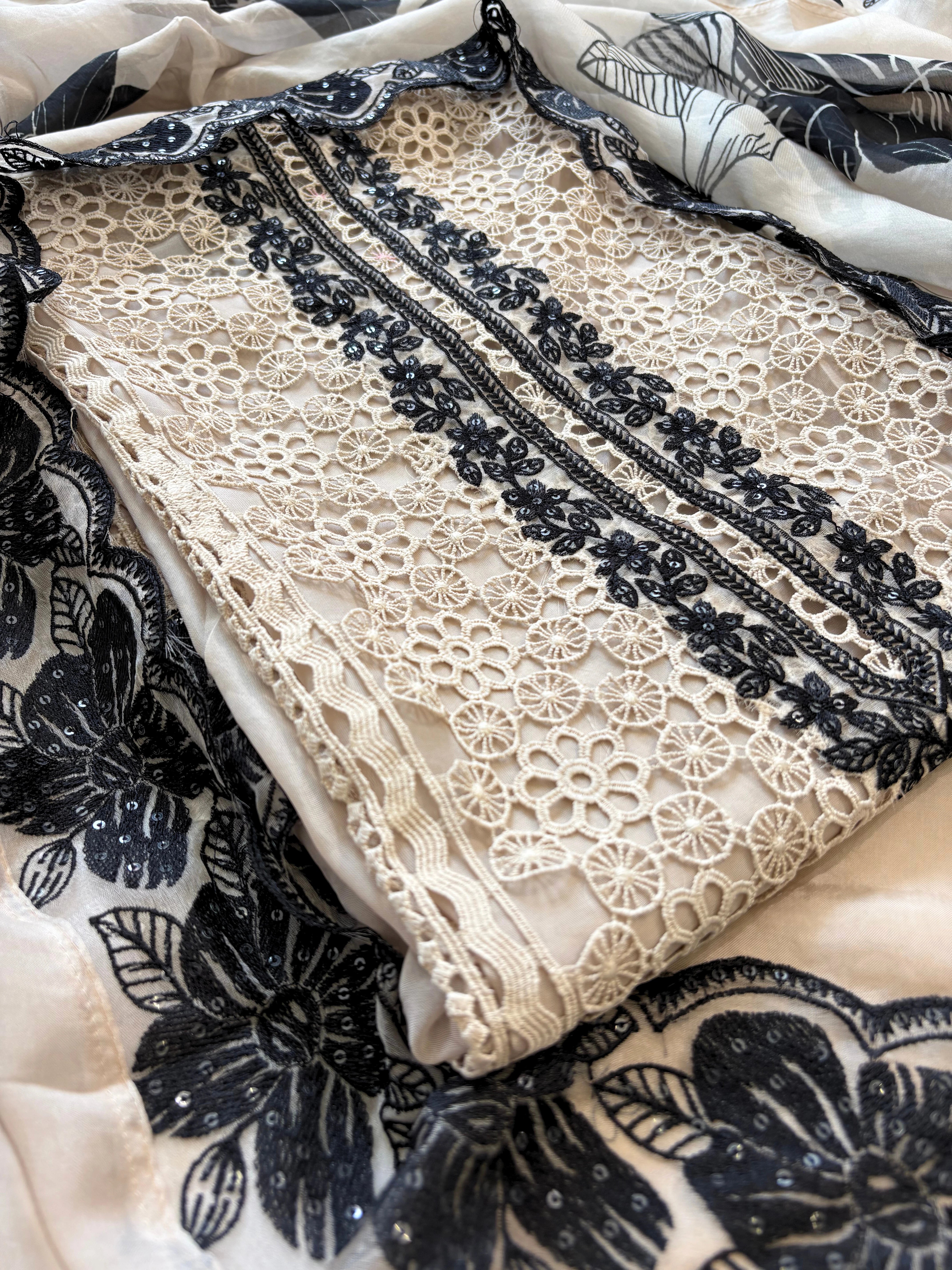 Ivory unstitched cutwork shirt with black applique embroidery and lace detailing, festive ethnic wear fabric
