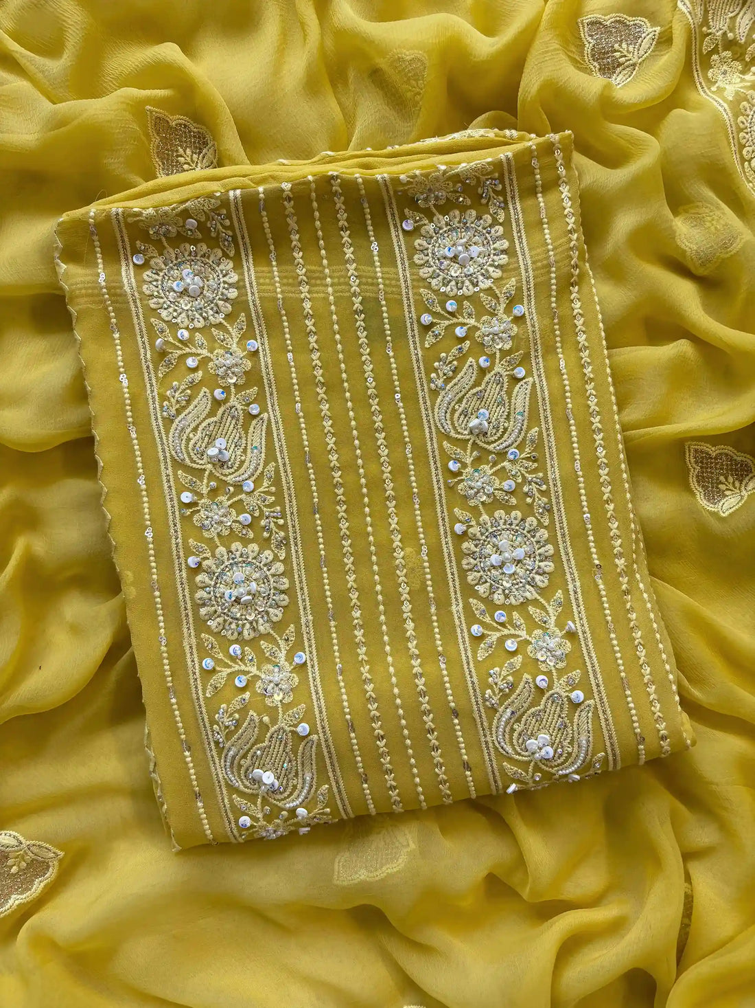 yellow georgette chikankari unstitched suit with moti and sequence embellishments