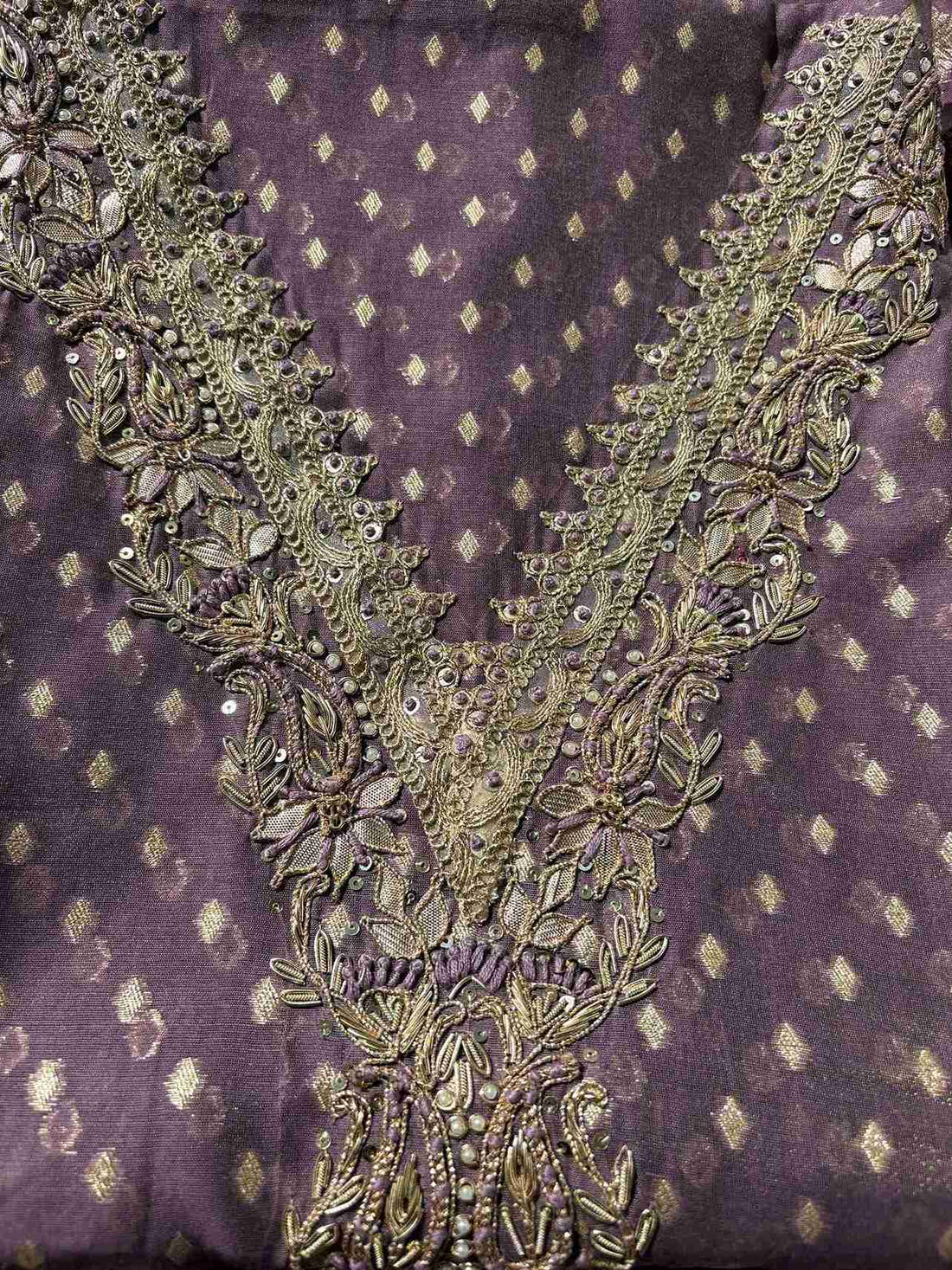 Detailed view of zardozi embroidered neckline on lavender organza suit fabric