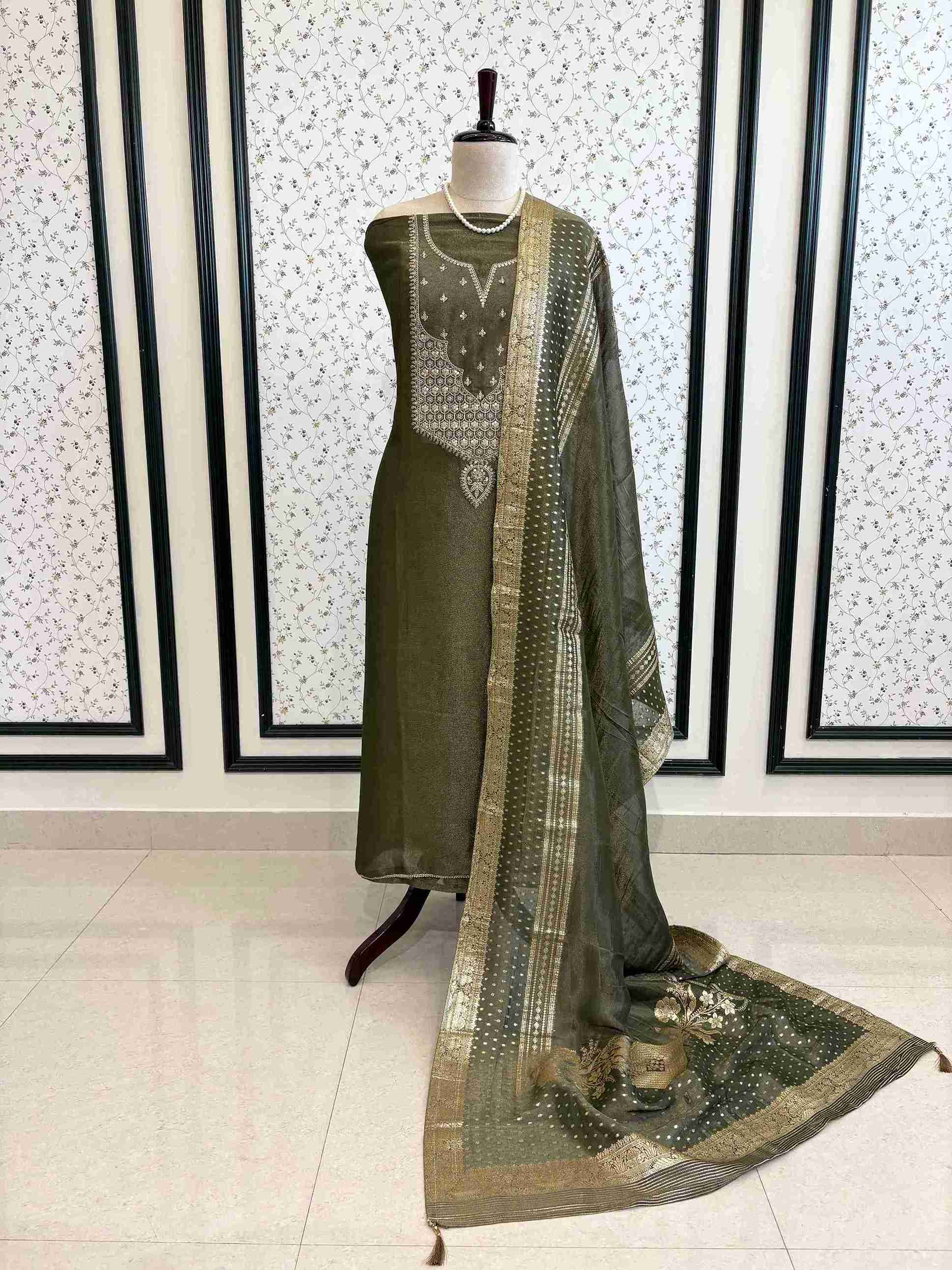 Elegant olive organza suit set with intricate zari neckline styling on mannequin – The Zareesh