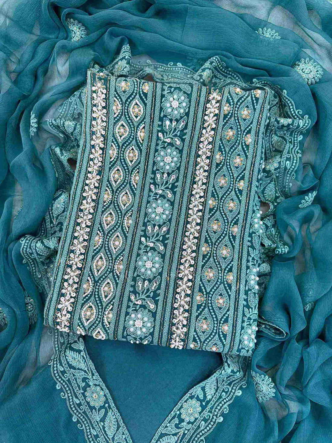 Chikankari unstitched suits on georgette fabric in teal color with moti and sequence highlighting
