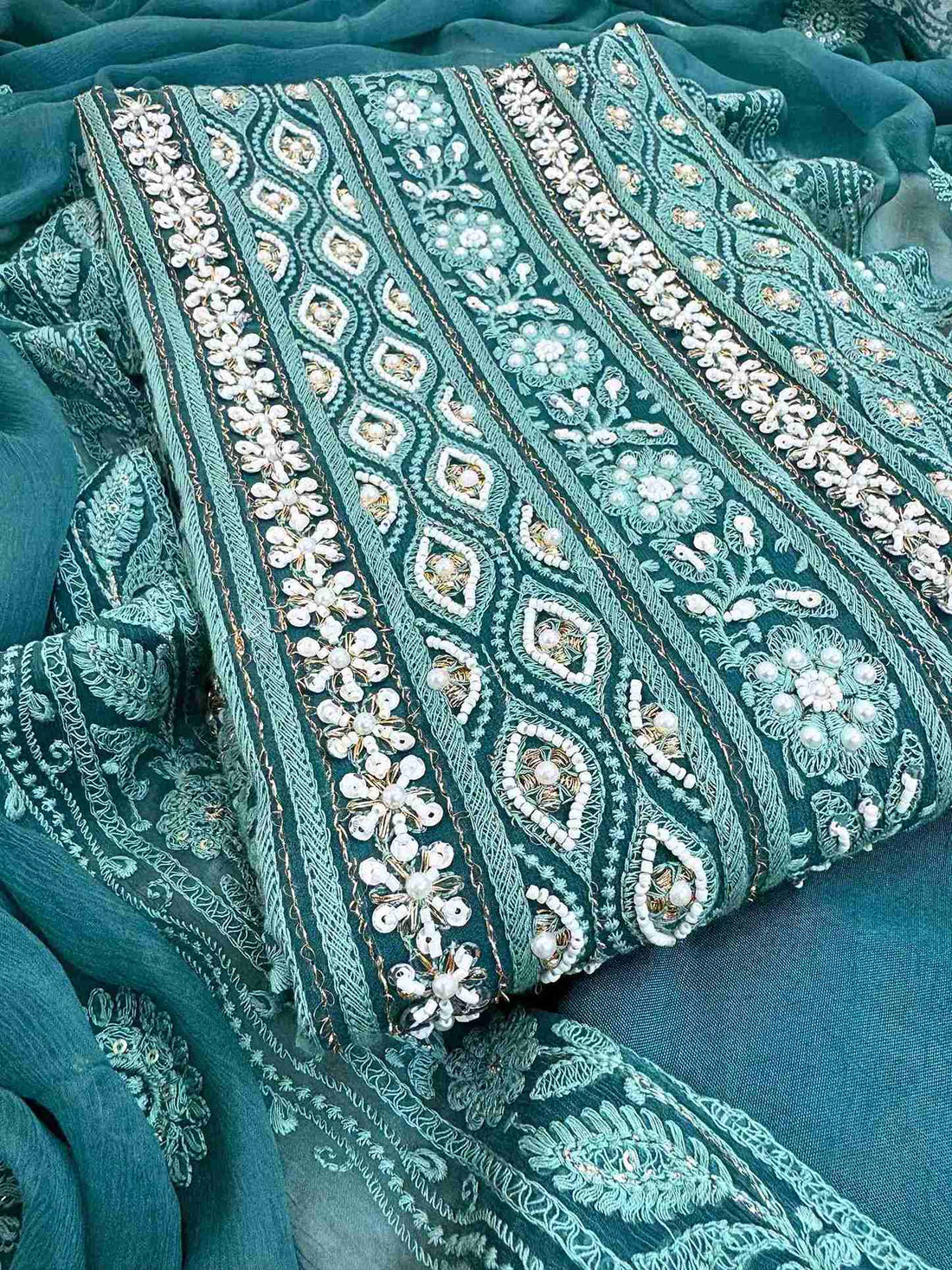 Chikankari unstitched suits on georgette fabric in teal color with moti and sequence highlighting
