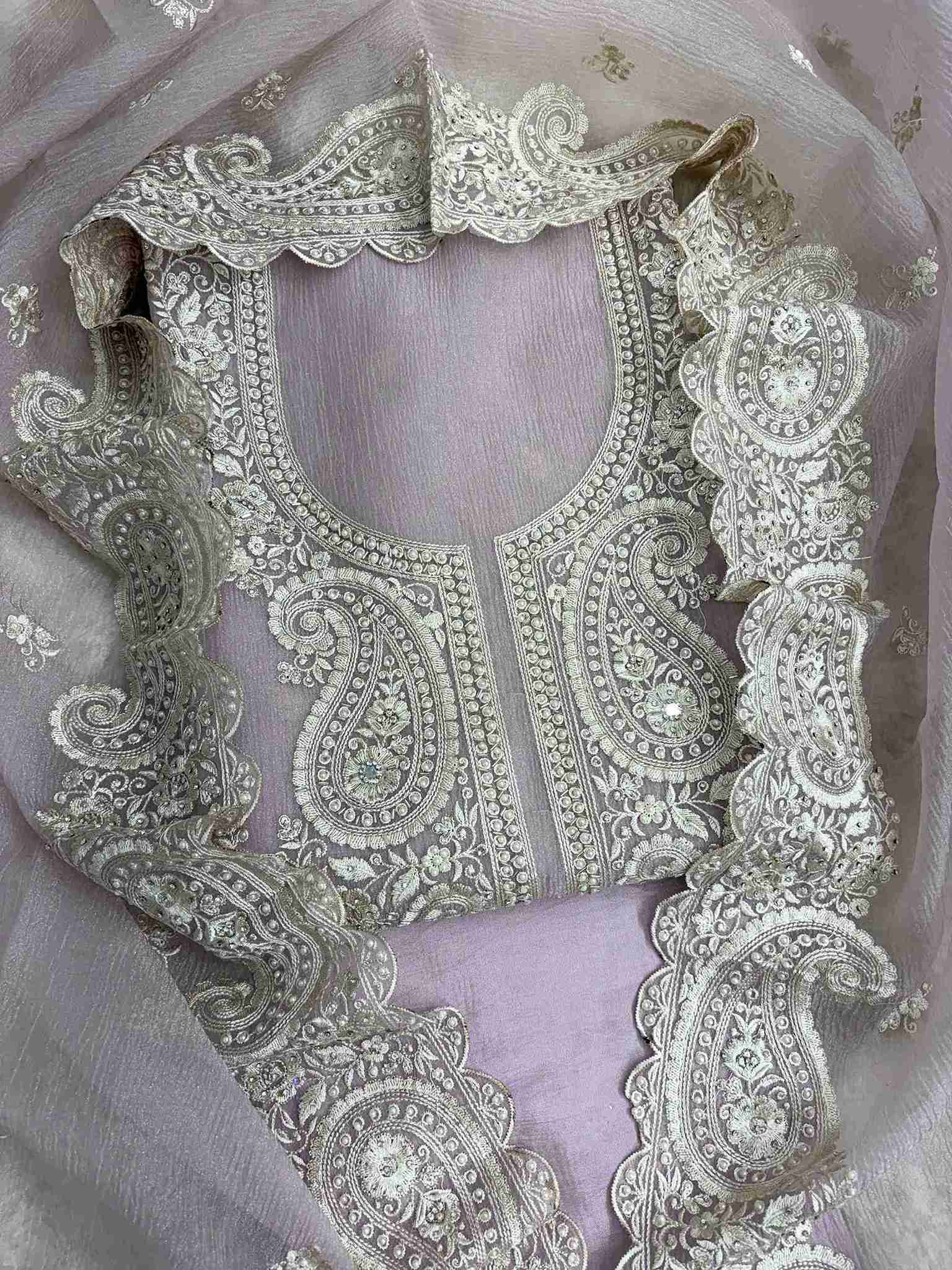 Close-up of intricate paisley neckline with cutdana, sequins, and pearl embellishments on Pink marble chiffon shirt