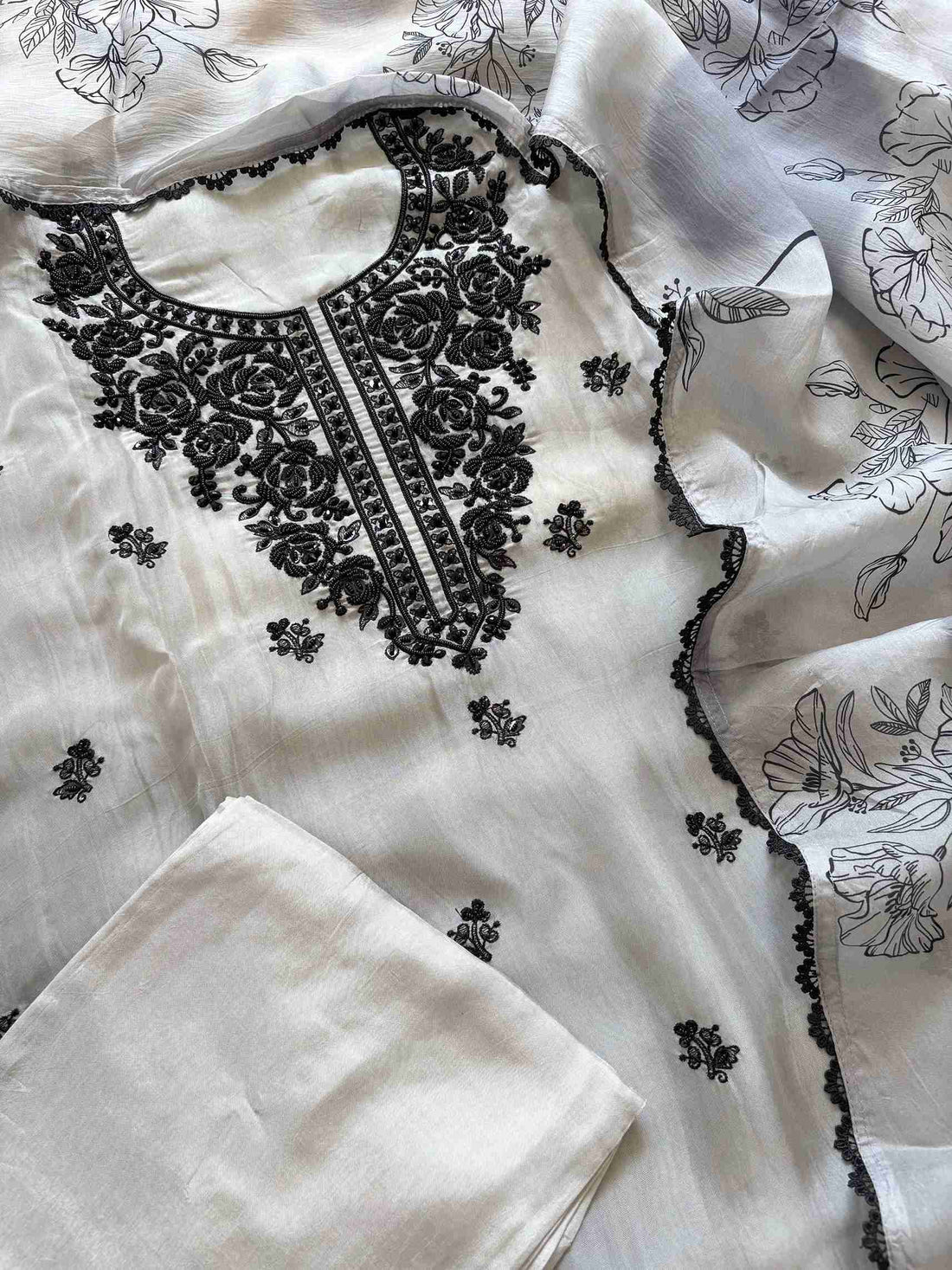 Thread booties and embroidered daaman on grey organza fabric and opada silk bottom