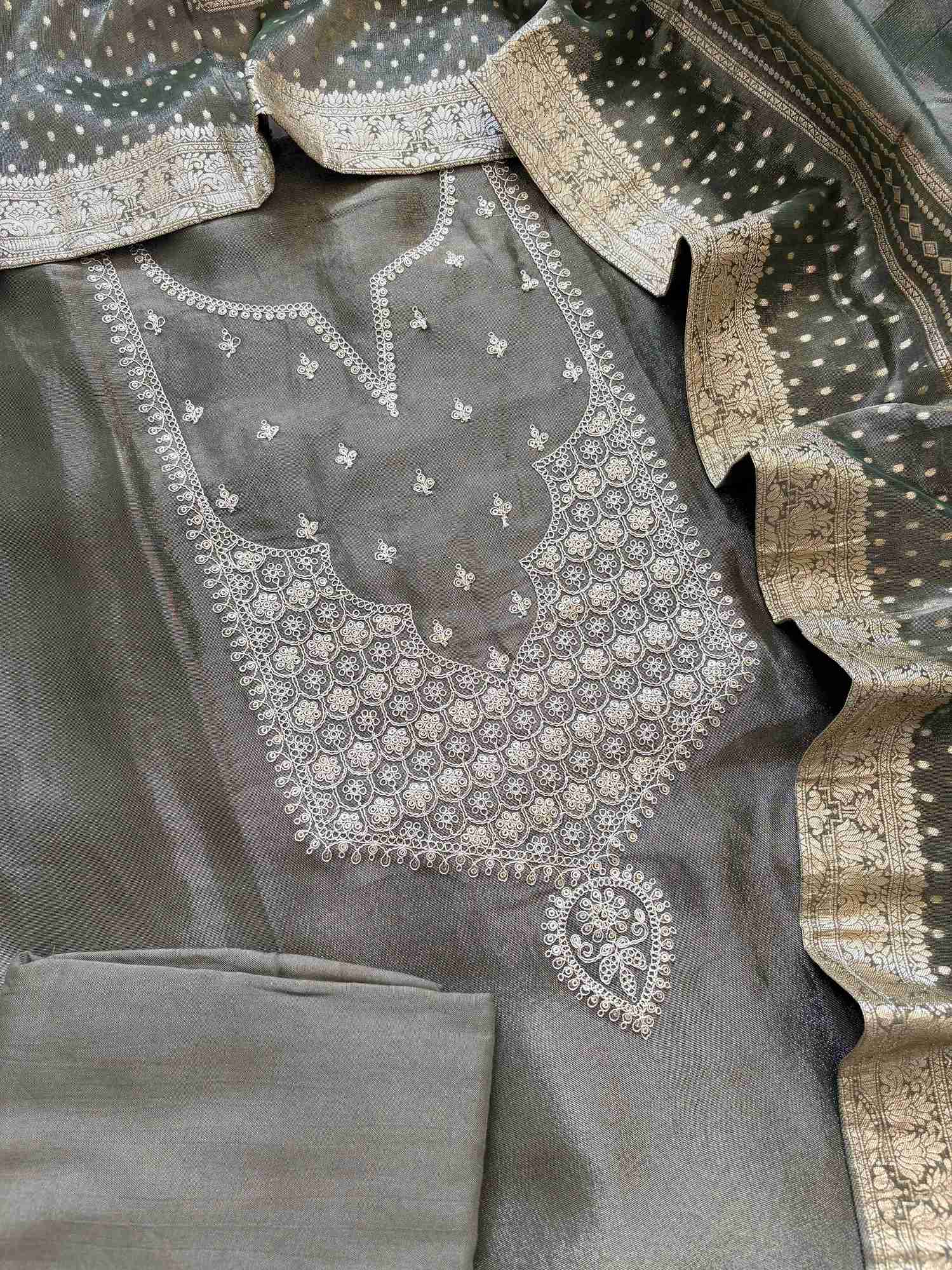 Zari-embroidered olive organza suit set with rich border dupatta on display